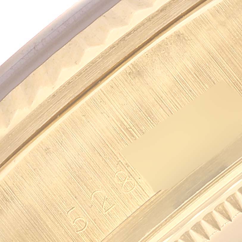 This close-up image shows the edge and markings of the case of a Rolex President 18038 Men's Yellow Gold Champagne Dial 18038 Men's Yellow Gold Champagne Dial model watch.