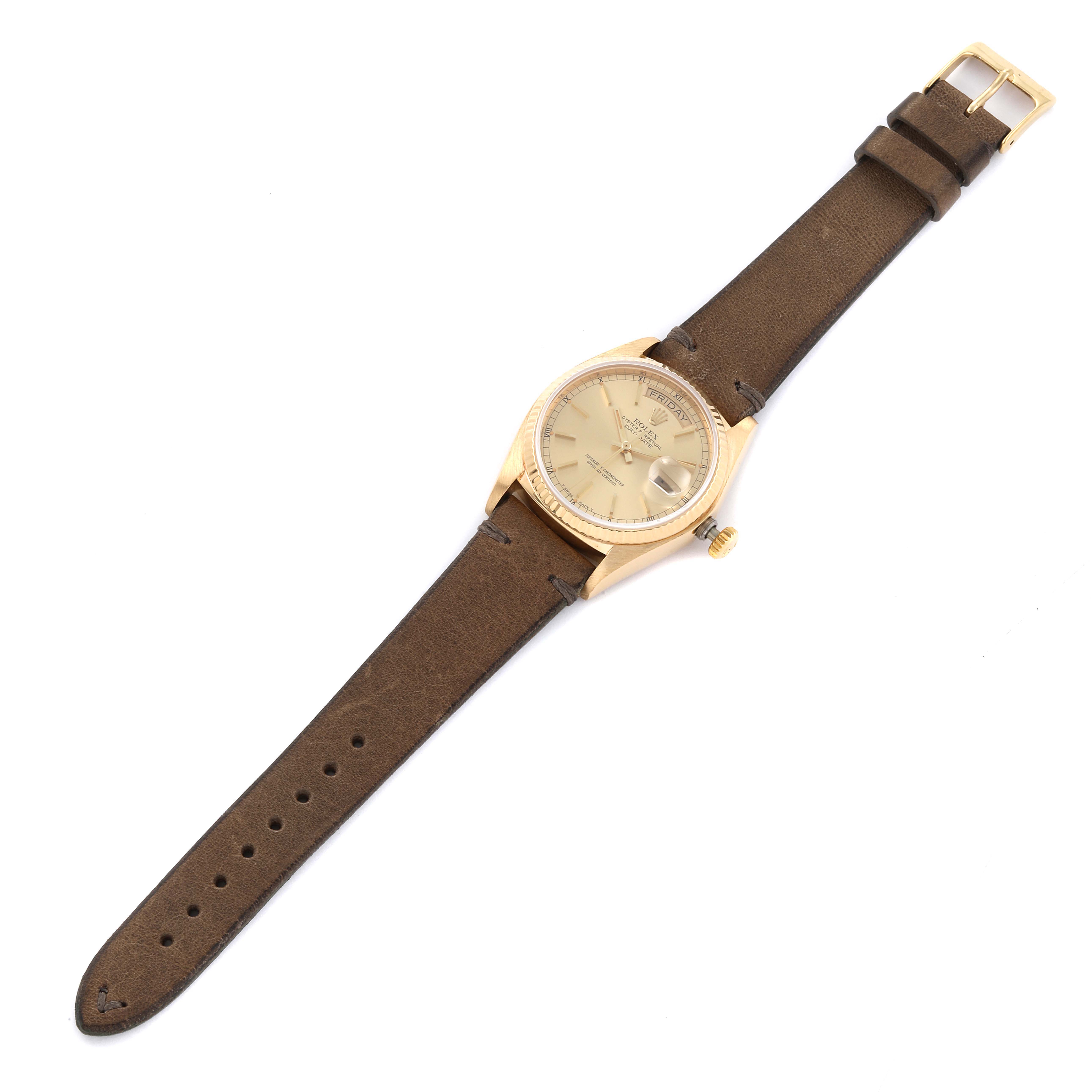 The Rolex President 18038 Men's Yellow Gold Champagne Dial 18038 Men's Yellow Gold Champagne Dial model watch is shown from a top view, displaying the watch face, case, crown, and leather strap.