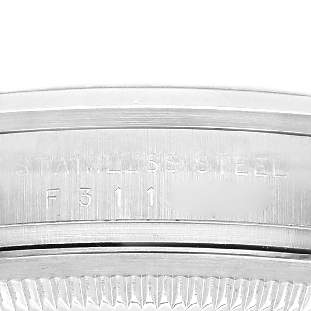 The image shows a close-up of the side of a Rolex Explorer 114270 Men's Stainless Steel Black Dial 114270 Men's Stainless Steel Black Dial watch, highlighting the stainless steel case with engraved details.