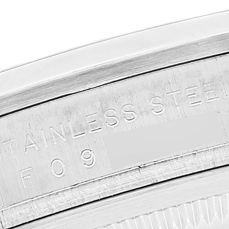 The image shows a close-up of the engraved stainless steel back of a Rolex Explorer 114270 Men
s Stainless Steel Black Dial 114270 Men
s Stainless Steel Black Dial watch.