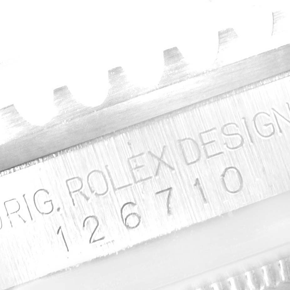 The image shows a close-up of the side of a Rolex GMT-Master 126710 Men's Stainless Steel Black Dial 126710 Men's Stainless Steel Black Dial watch, focusing on the bezel and engraved model number 126710.