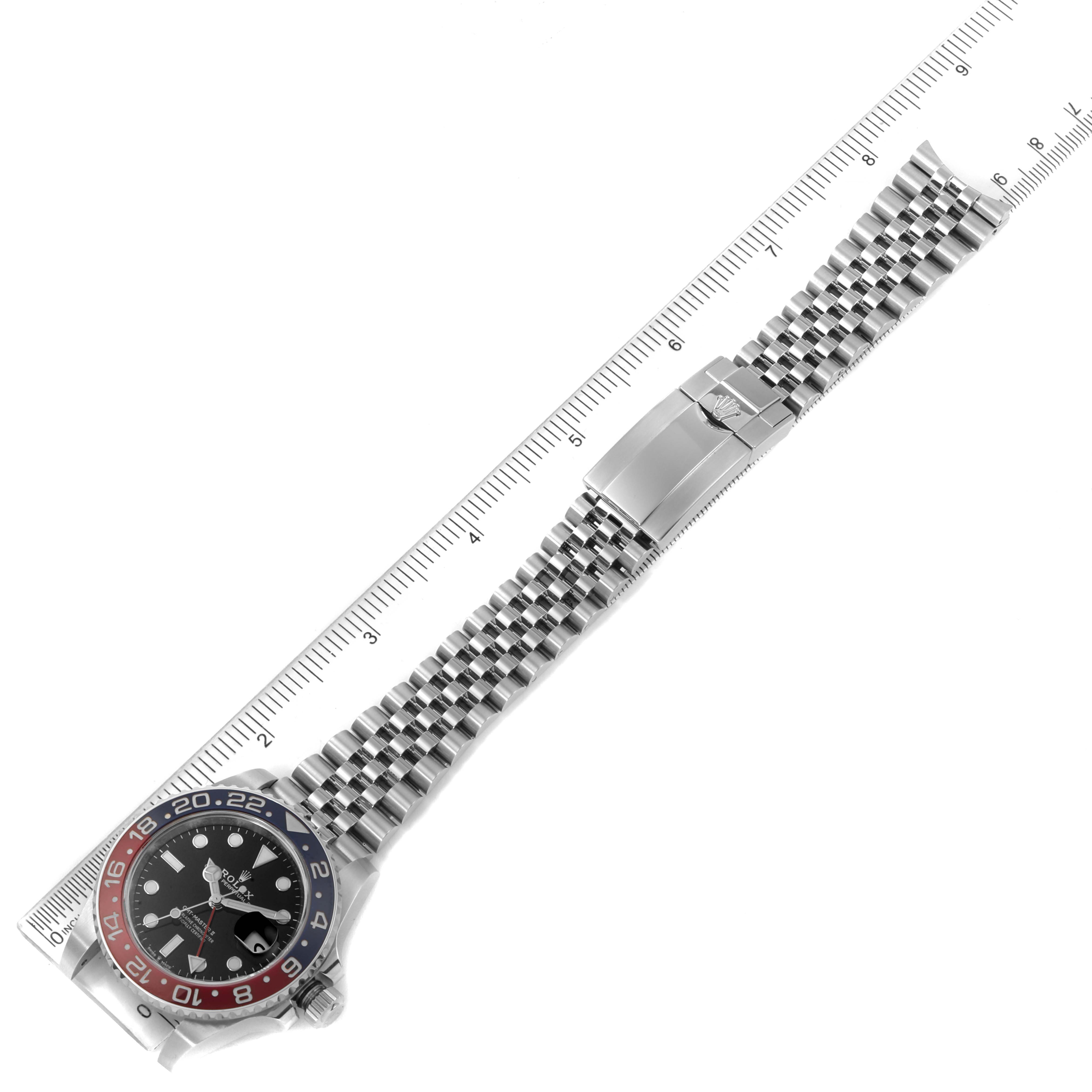 The Rolex GMT-Master 126710 Men's Stainless Steel Black Dial 126710 Men's Stainless Steel Black Dial watch is shown from an overhead angle, displaying its face, bezel, and metal bracelet.