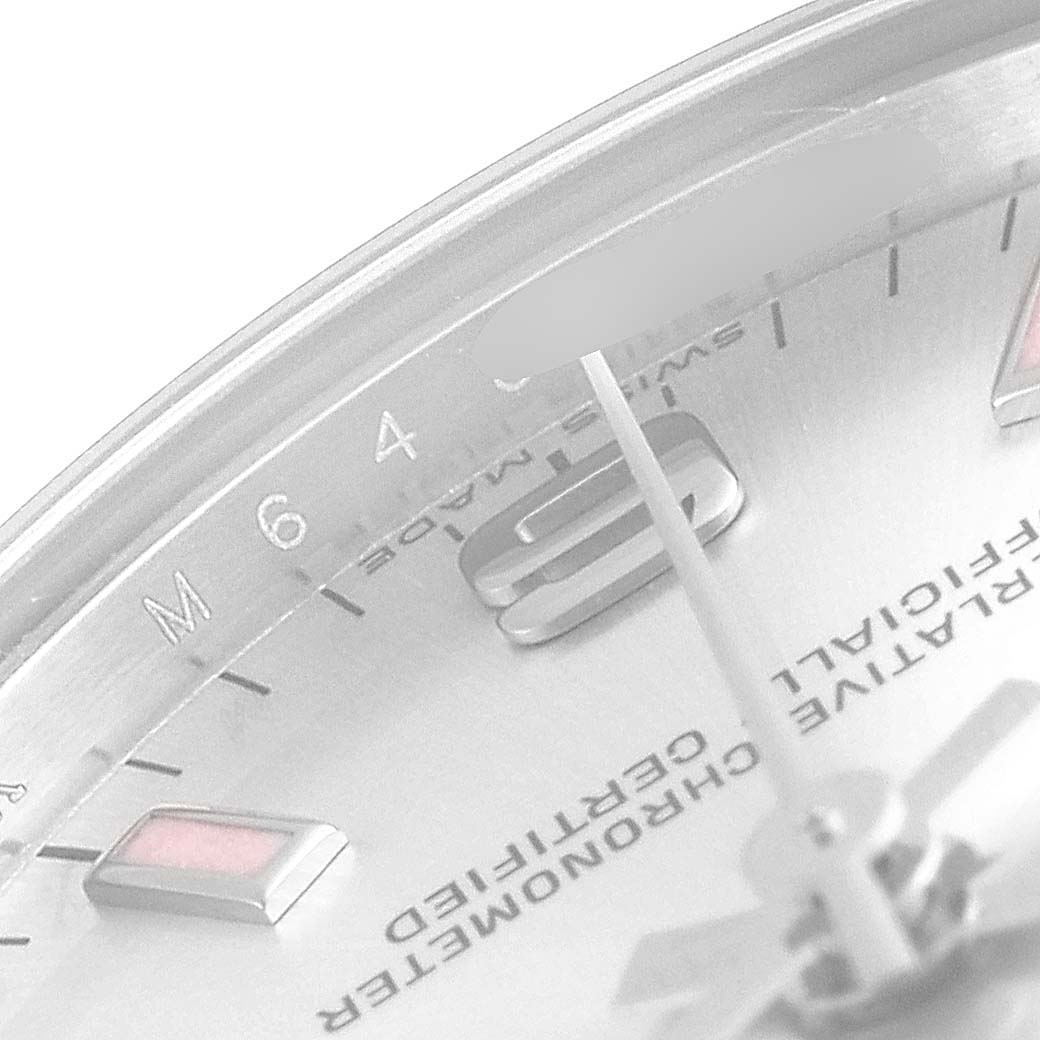 This image shows a close-up of the dial and markers of a Mid-Size Rolex watch, viewed from an oblique angle.