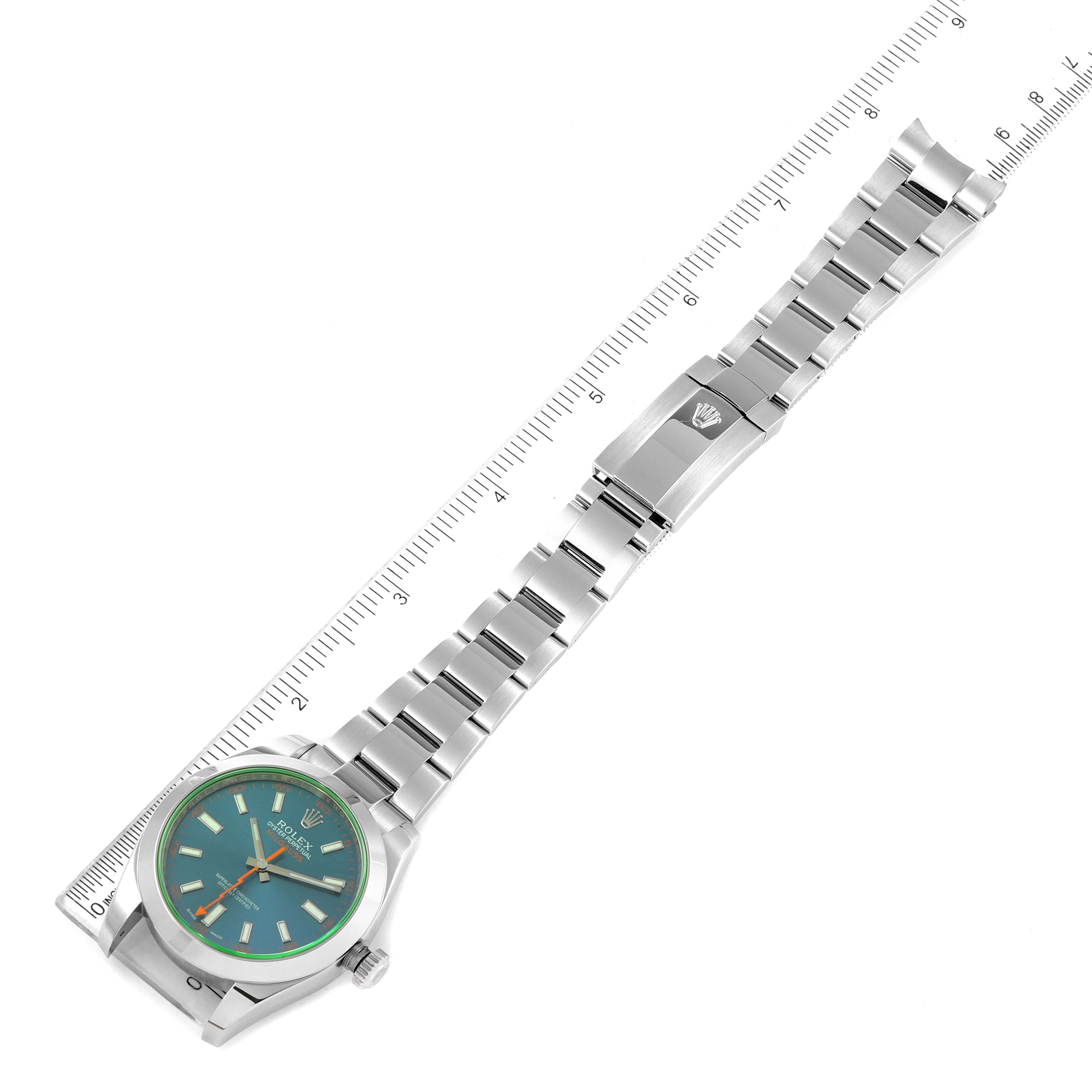 The Rolex Milgauss 116400GV Men's Stainless Steel Blue Dial 116400GV Men's Stainless Steel Blue Dial watch is shown laid flat, displaying its face, bracelet, and clasp with a ruler for scale.