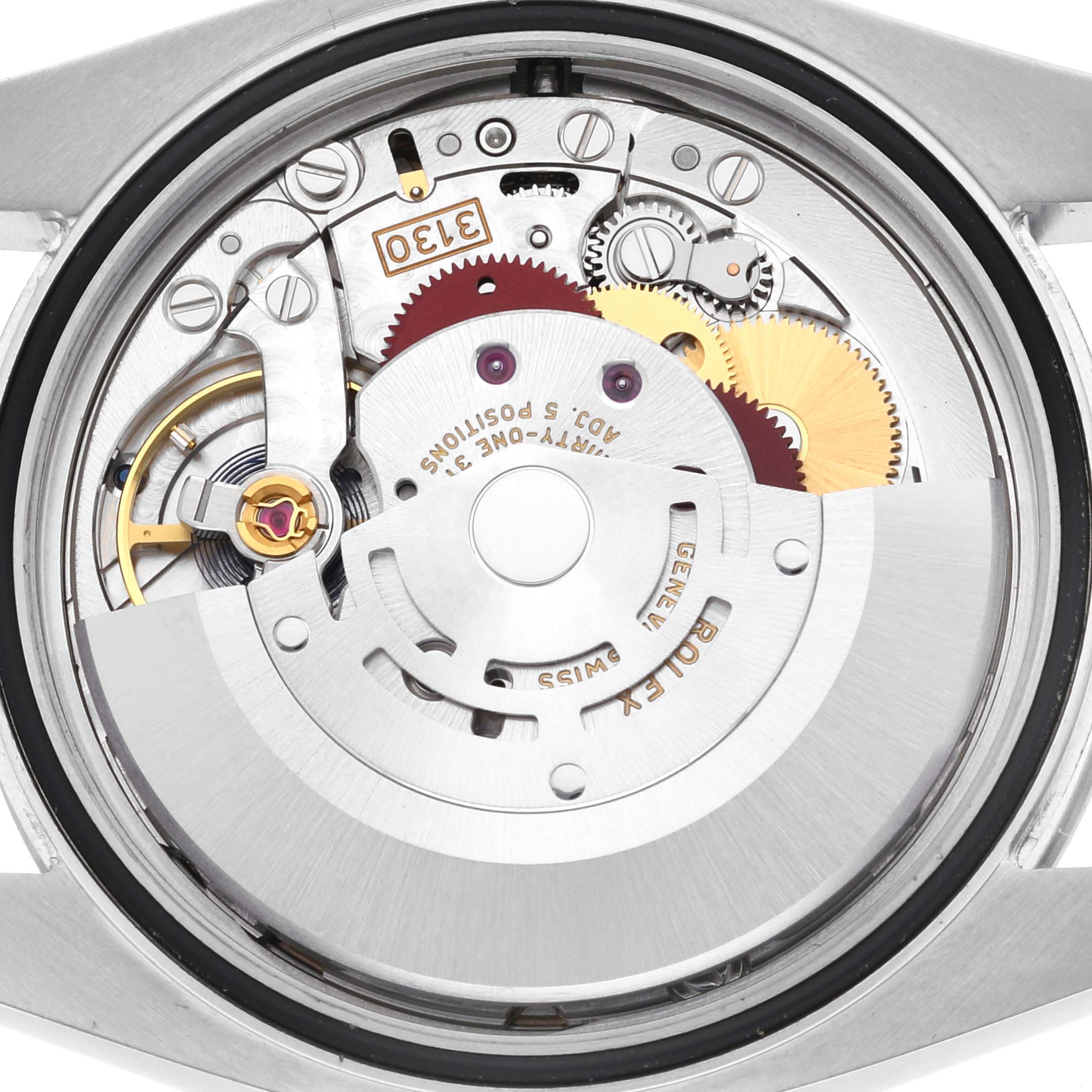 The image shows the movement and internal mechanisms of a Rolex Oyster Perpetual 116000 Men's Stainless Steel Yellow Dial 116000 Men's Stainless Steel Yellow Dial watch from a rear angle.