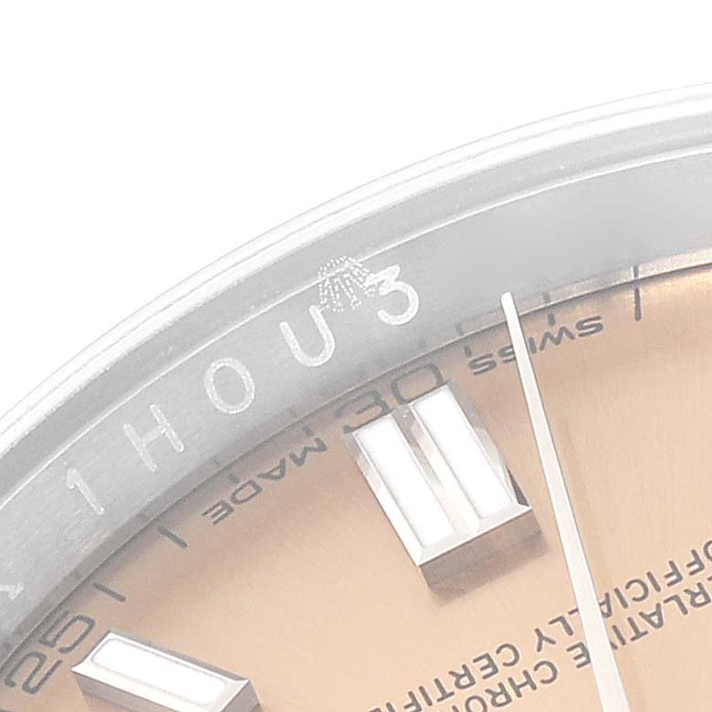 This close-up image shows part of the dial and the outer bezel of a Rolex Oyster Perpetual 116000 Men's Stainless Steel Yellow Dial 116000 Men's Stainless Steel Yellow Dial watch, highlighting the hour markers and inscriptions.