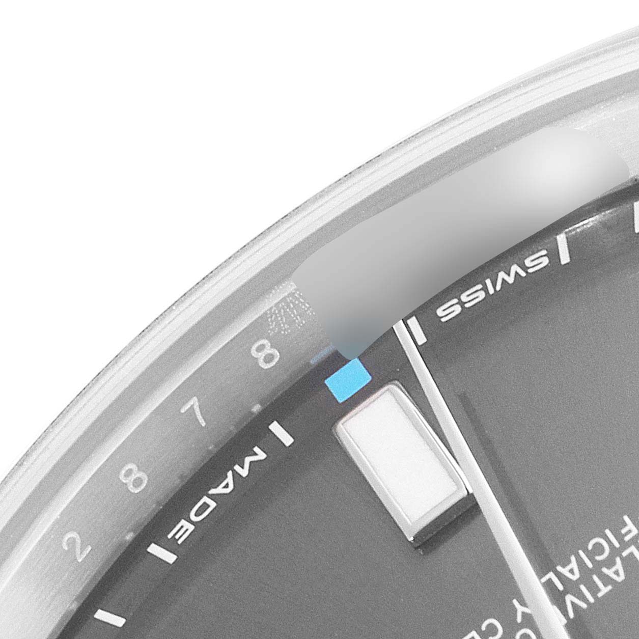 The image shows a close-up of the dial of a Rolex Oyster Perpetual 114300 Men's Stainless Steel Grey Dial 114300 Men's Stainless Steel Grey Dial watch, highlighting the Swiss made markings and part of the hour markers.