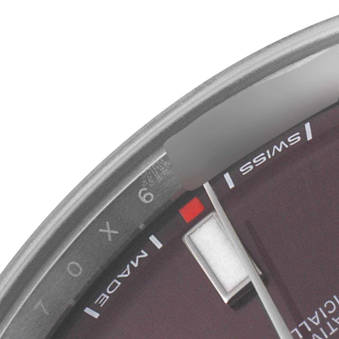 This is a close-up of the dial of a Rolex Oyster Perpetual 114300 Men
s Stainless Steel Burgundy Dial 114300 Men
s Stainless Steel Burgundy Dial watch, showing part of the hour markers and the "Swiss Made" text.
