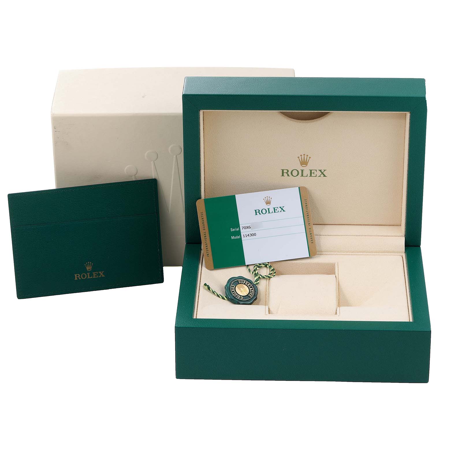 The image shows the packaging, box, and accessories (including tags and warranty card) of the Rolex Oyster Perpetual 114300 Men
s Stainless Steel Burgundy Dial 114300 Men
s Stainless Steel Burgundy Dial watch.