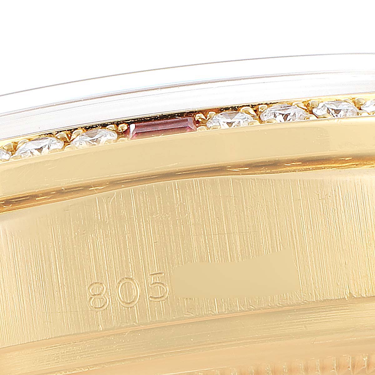 This close-up of the Rolex President 18148 Men's Yellow Gold Champagne Dial 18148 Men's Yellow Gold Champagne Dial watch shows part of the gold case and a jeweled edge detail.