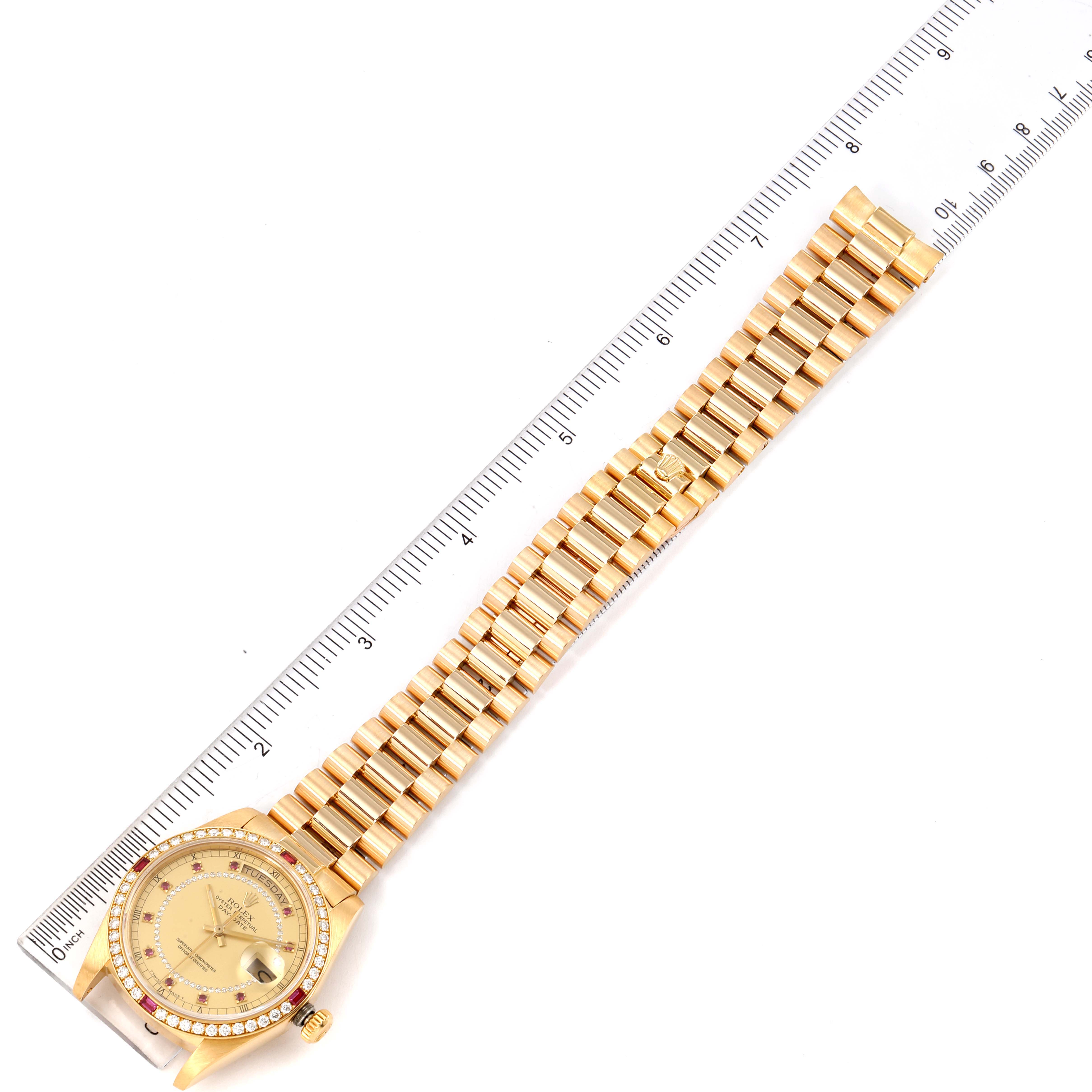 The image shows a full frontal view of a Rolex President 18148 Men's Yellow Gold Champagne Dial 18148 Men's Yellow Gold Champagne Dial model watch, displaying its strap and dial with a ruler alongside.