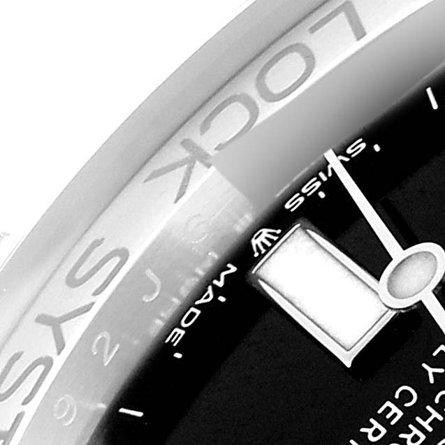 This close-up image of the Rolex Sea-Dweller 126660 Men's Stainless Steel Black Dial 126660 Men's Stainless Steel Black Dial watch shows the bezel and part of the dial with the hour hand.