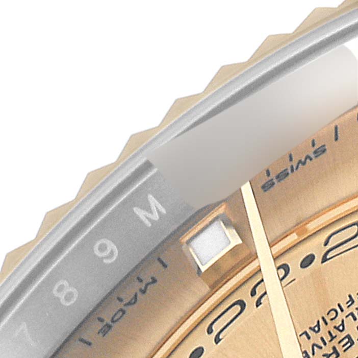 This image shows a close-up of the dial and bezel of the Rolex Sky-Dweller 326933 Men's Steel and Gold (two tone) Champagne Dial 326933 Men's Steel and Gold (two tone) Champagne Dial watch, highlighting numerals and part of the minute hand.