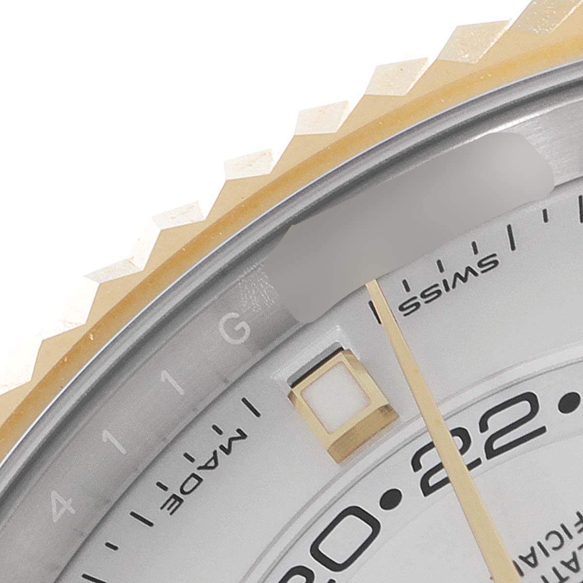 This close-up image of a Rolex Sky-Dweller 326933 Men's Steel and Gold (two tone) White Dial 326933 Men's Steel and Gold (two tone) White Dial watch shows part of the bezel, dial, and minute markers.