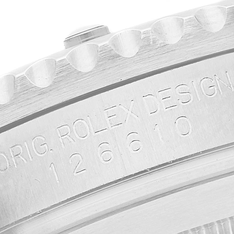 This close-up image shows the engraved serial number and bezel of a Rolex Submariner 126610 Men's Stainless Steel Black Dial 126610 Men's Stainless Steel Black Dial watch.