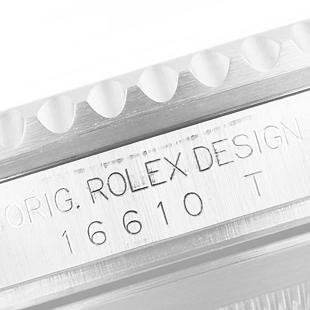 The image shows a close-up of the case side and the serial number engraving of a Rolex Submariner 16610LV Men's Stainless Steel Black Dial 16610LV Men's Stainless Steel Black Dial watch.