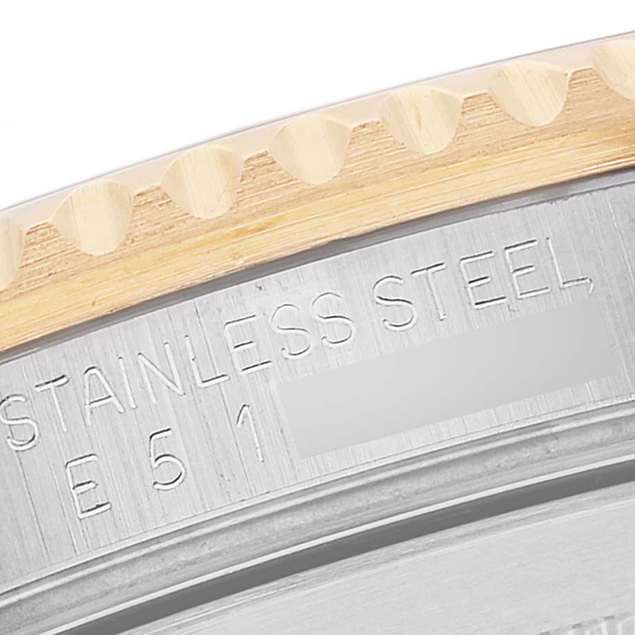 This image shows a close-up of the bezel and case back of a Rolex Submariner 16613 Men's Steel and Gold (two tone) Champagne Dial 16613 Men's Steel and Gold (two tone) Champagne Dial, highlighting its stainless steel markings.