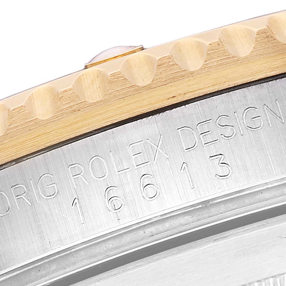 This close-up image of a Rolex Submariner 16613 Men's Steel and Gold (two tone) Champagne Dial 16613 Men's Steel and Gold (two tone) Champagne Dial shows part of the bezel and case with the model number "16613" engraved.