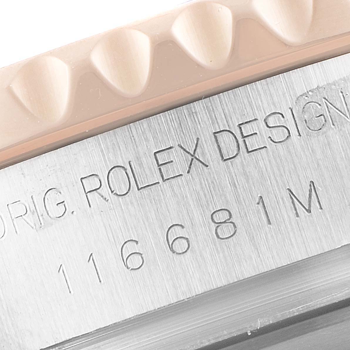 The image shows a close-up of a Rolex Yacht-Master 116681 Men's Rose Gold White Dial 116681 Men's Rose Gold White Dial watch's bezel, case, and engraved model number.