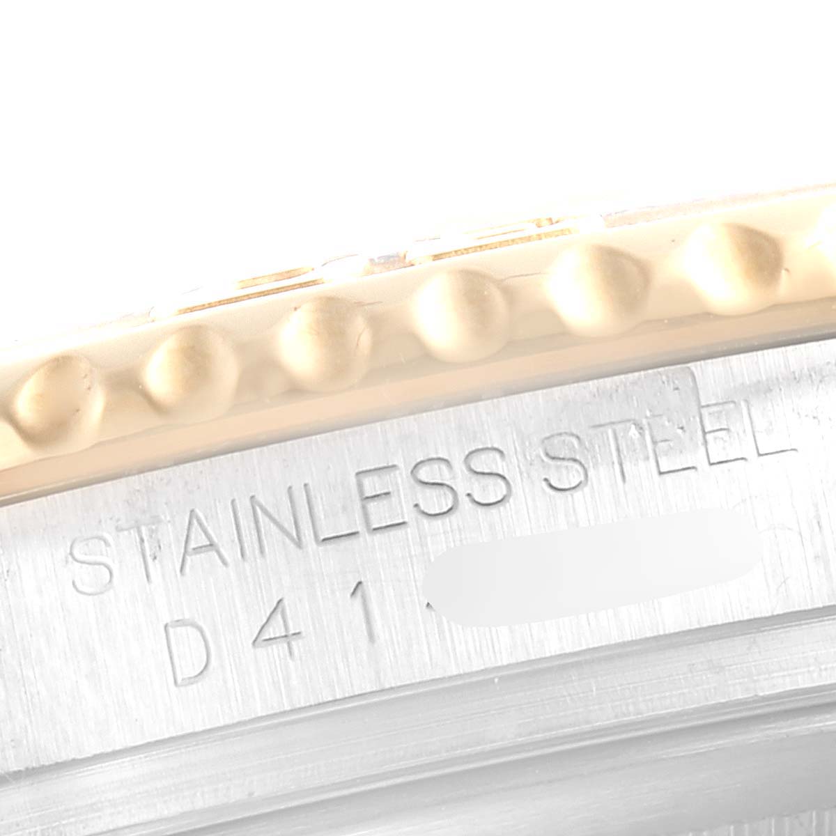 This close-up image of the Rolex Yacht-Master 16623 Men's Steel and Gold (two tone) White Dial 16623 Men's Steel and Gold (two tone) White Dial watch shows part of the stainless steel case and the edge of the bezel.