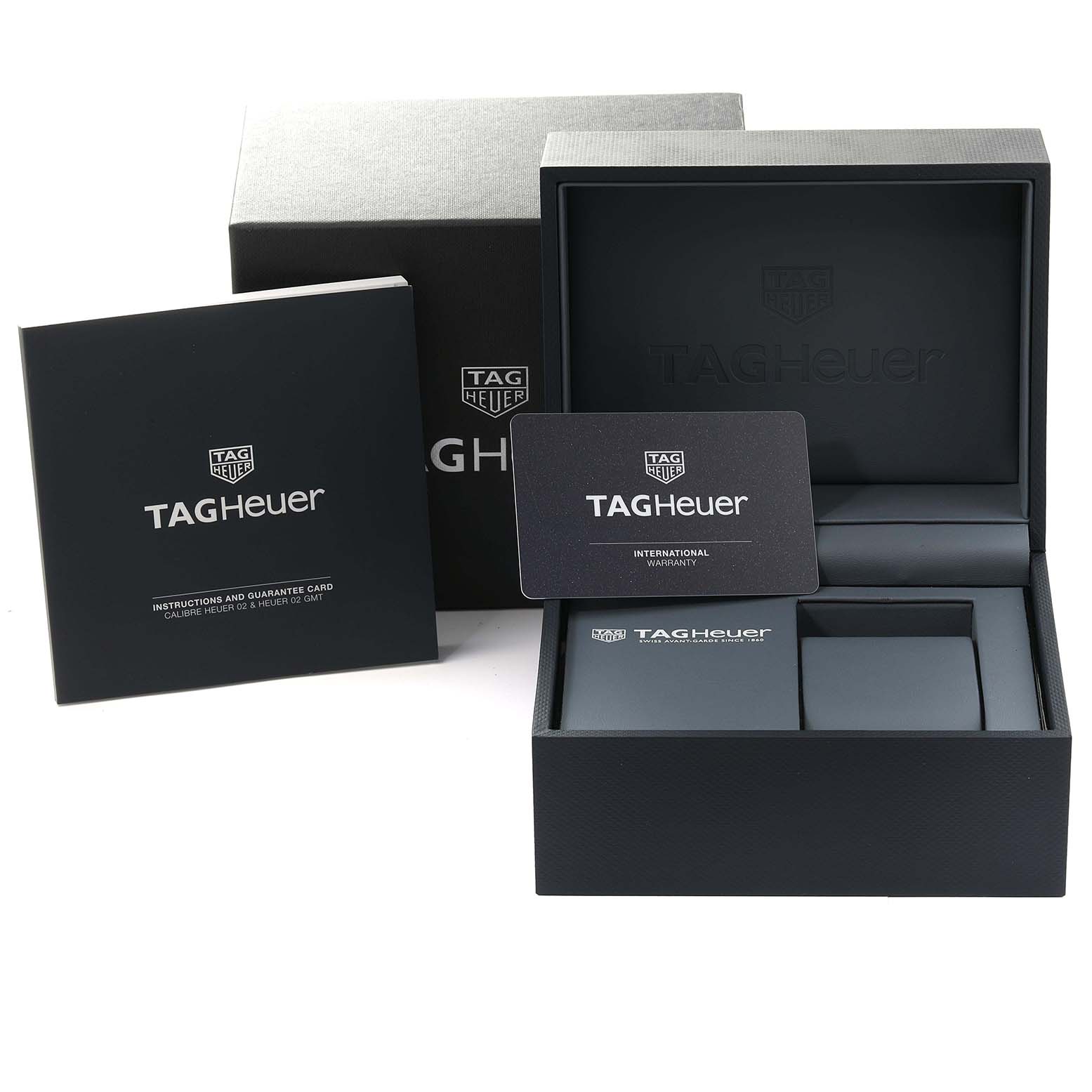 This image shows the packaging, instruction manual, and international warranty card for a Tag Heuer Monaco CBL2111.FC6453 Men's Stainless Steel Blue Dial CBL2111.FC6453 Men's Stainless Steel Blue Dial watch.