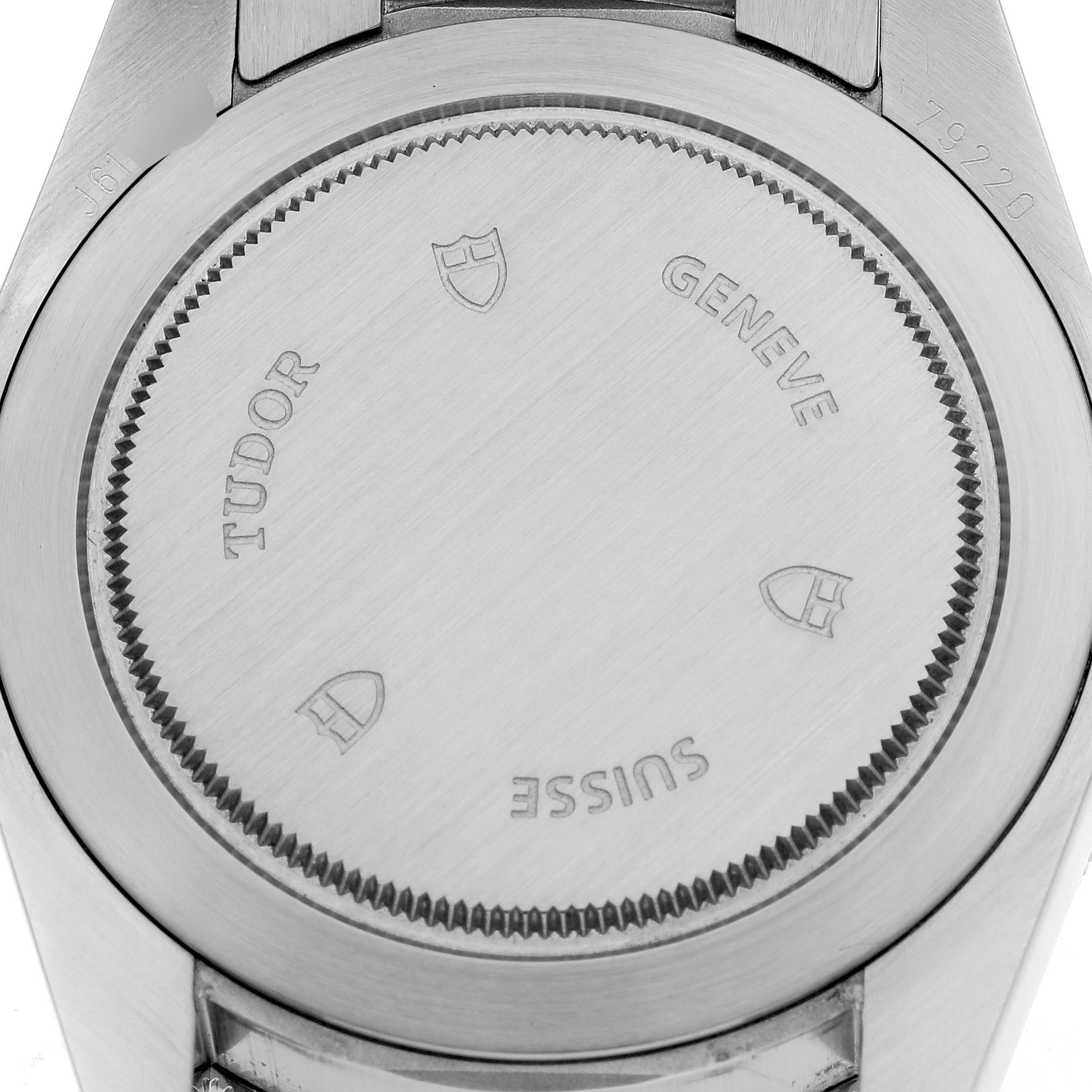 The image shows the case back of a Tudor Heritage Black Bay 79220R Men's Stainless Steel Black Dial 79220R Men's Stainless Steel Black Dial watch, displaying branding and manufacturing details.