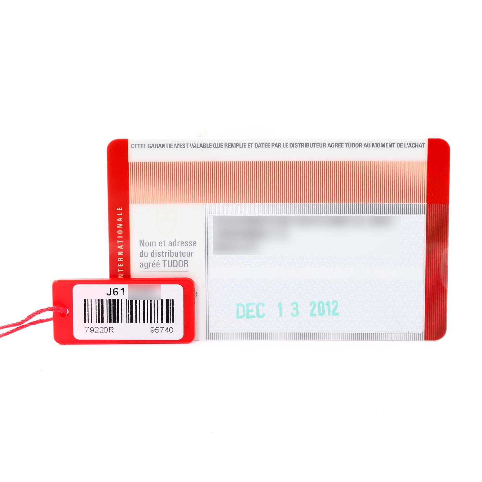 The image shows the warranty card and a hang tag for the Tudor Heritage Black Bay 79220R Men's Stainless Steel Black Dial 79220R Men's Stainless Steel Black Dial watch model.