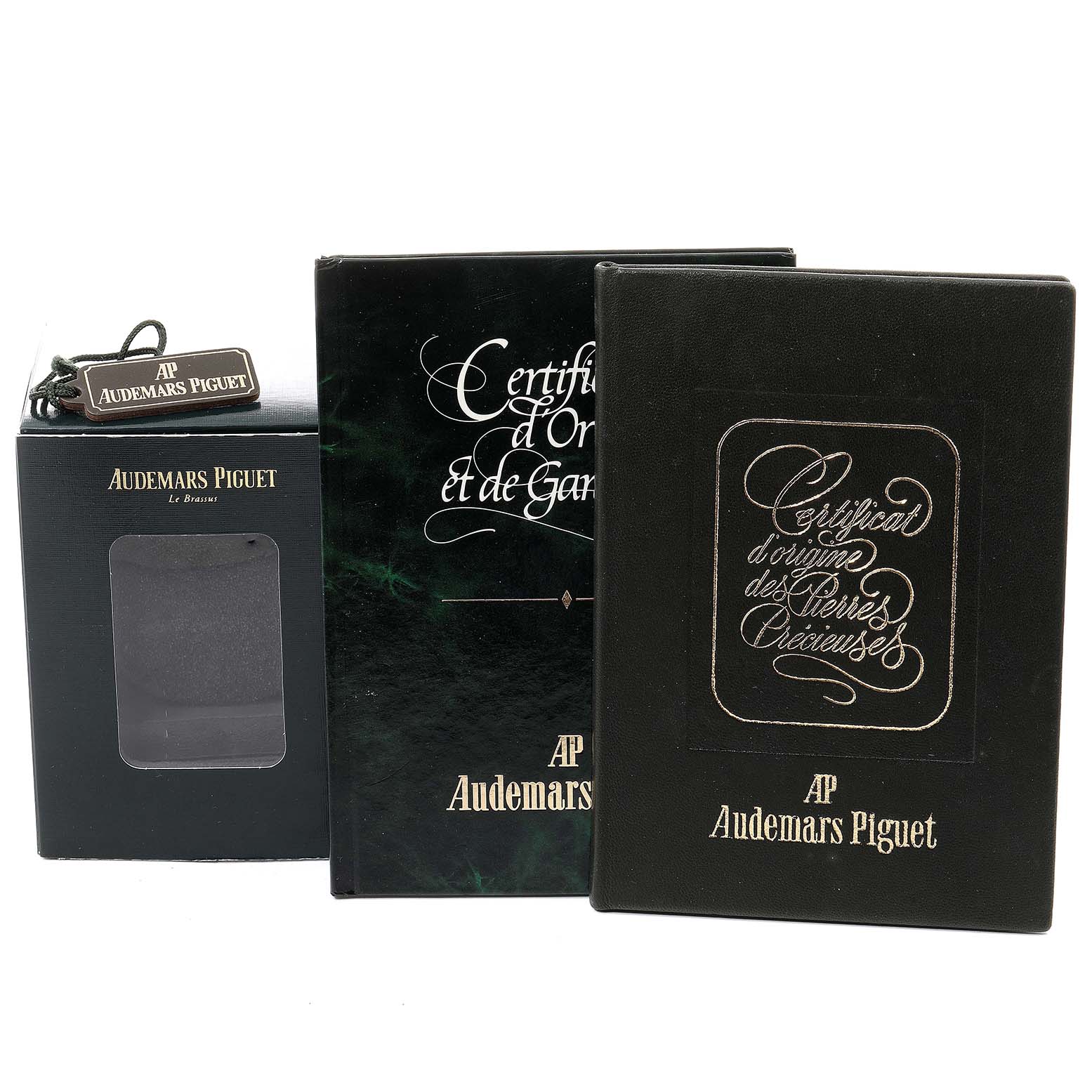 The image shows packaging and certification materials for an Audemars Piguet Royal Oak 14587BA.Z.0902BA.01 Women
s Yellow Gold Champagne Dial 14587BA.Z.0902BA.01 Women
s Yellow Gold Champagne Dial watch, including a box, booklets, and a hang tag.