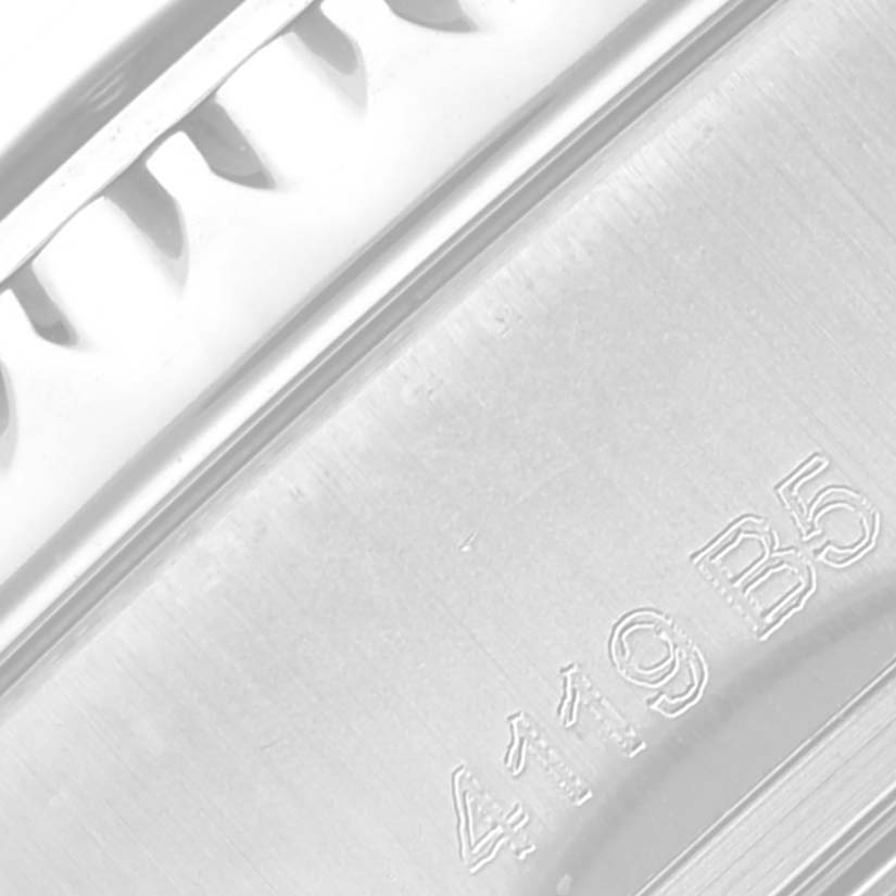 The image shows a close-up of the engraved side of the Breitling Aviator AB01192A1L1A1 Men's Stainless Steel Green Dial AB01192A1L1A1 Men's Stainless Steel Green Dial watch, highlighting its detailed metal casing.