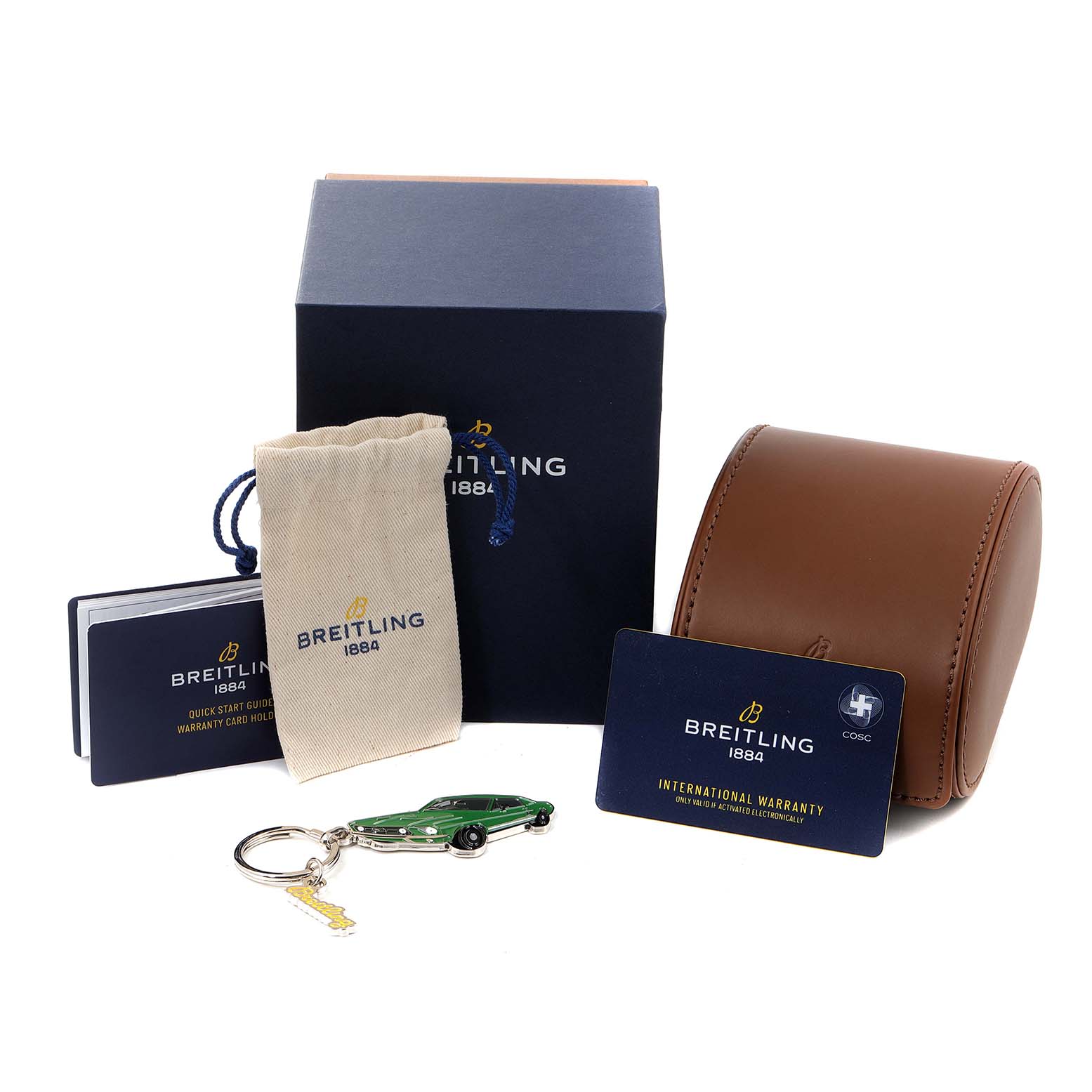 The image shows the packaging and accessories for the Breitling Limited Series watch, including a box, pouch, warranty card, and keychain.