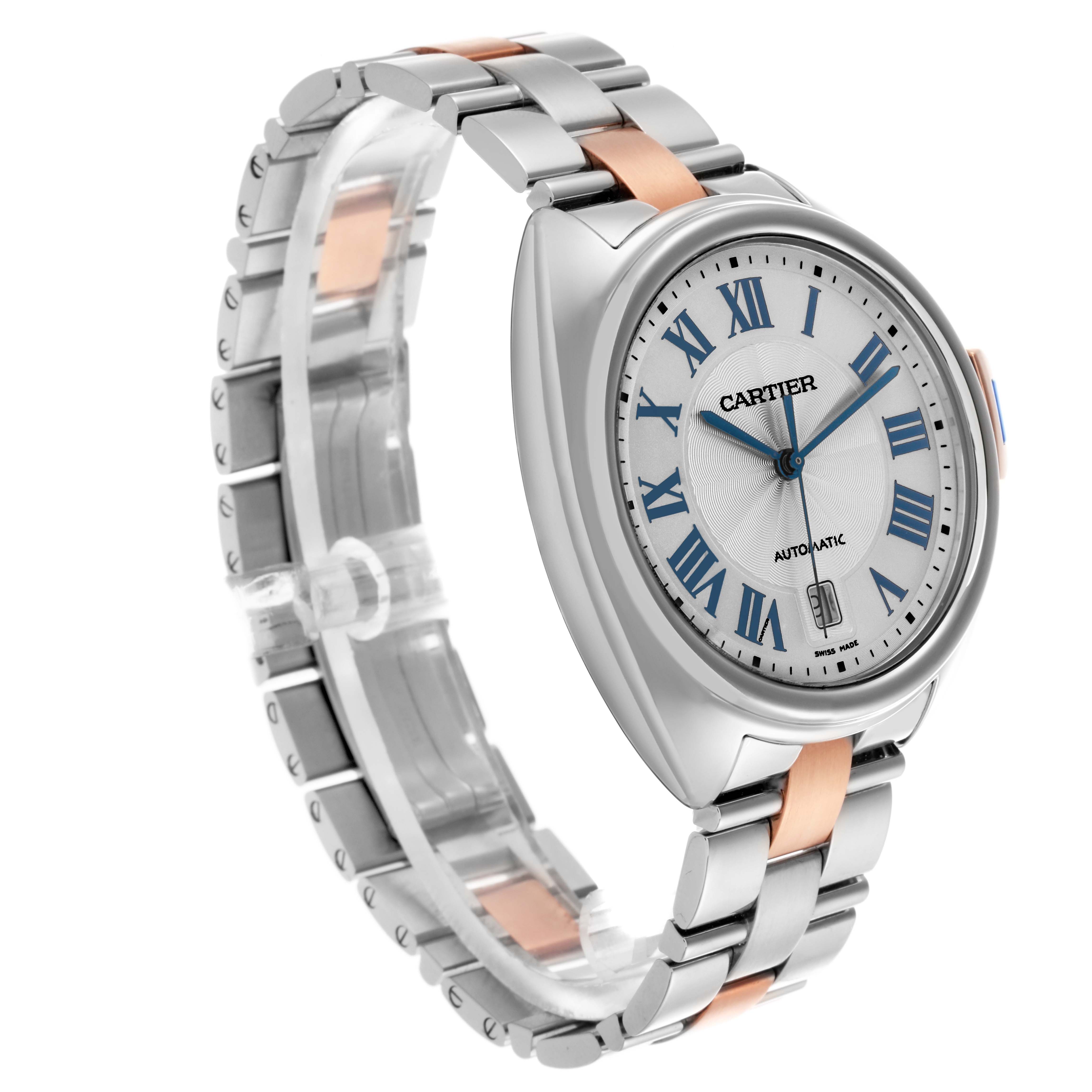 The Cartier Clé watch is shown from a three-quarter angle, highlighting the dial, bracelet, and side profile.