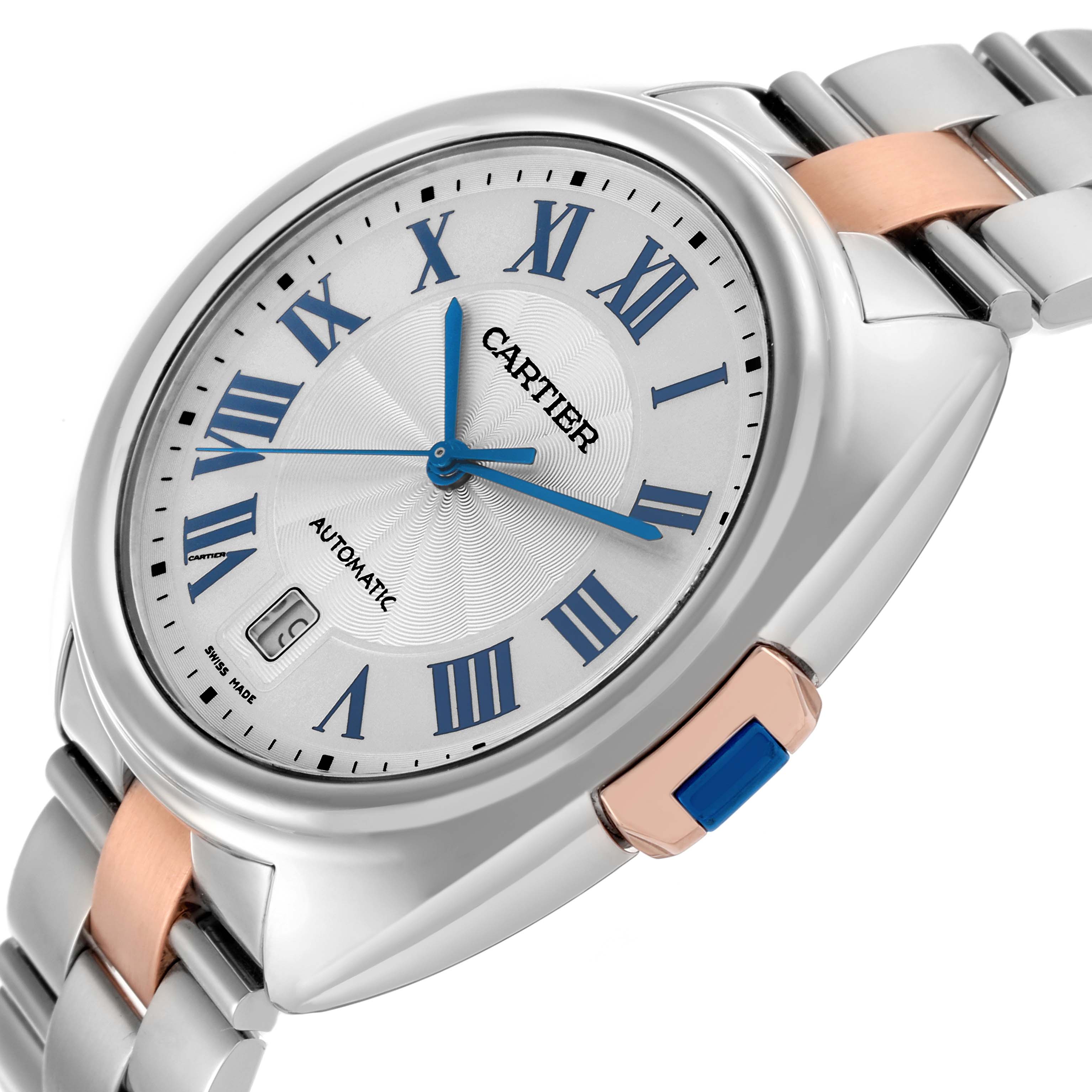 The Cartier Clé watch is shown at a three-quarter angle, highlighting the face, silver and rose gold bracelet, and crown detail.