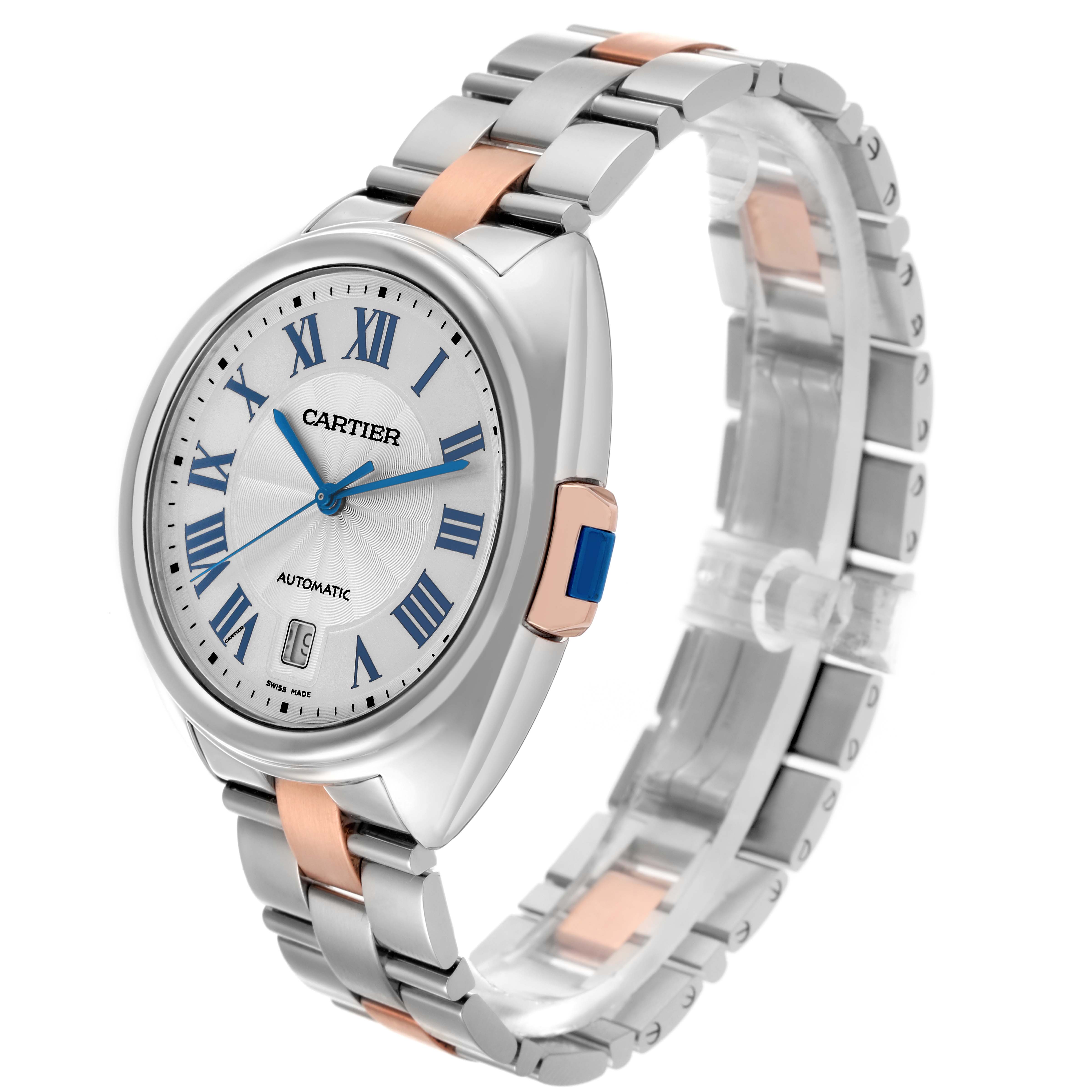 The Cartier Clé watch is shown at a three-quarter view, highlighting its face, crown, and two-tone bracelet.