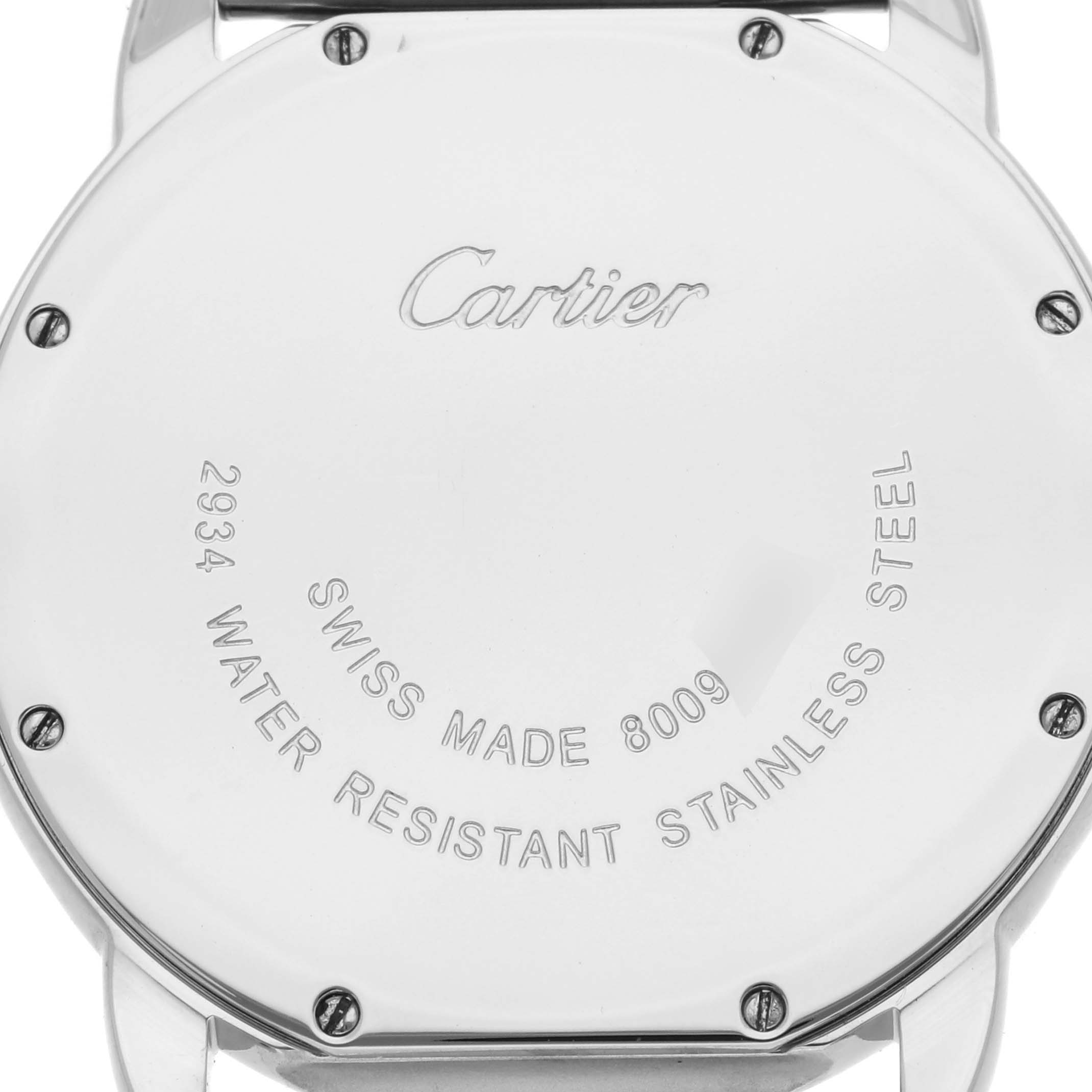 The image shows the back case of a Cartier Ronde W6701005 Men
s Stainless Steel Silver Dial W6701005 Men
s Stainless Steel Silver Dial watch, displaying engraved text and screws.