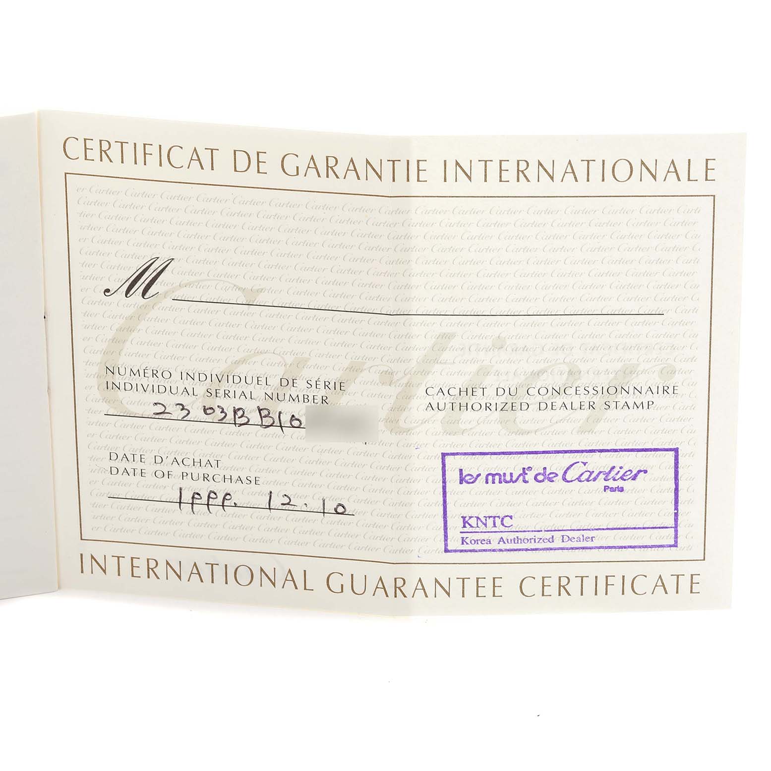 The image shows an International Guarantee Certificate for a Cartier Tank Française watch, featuring dealer and purchase details.