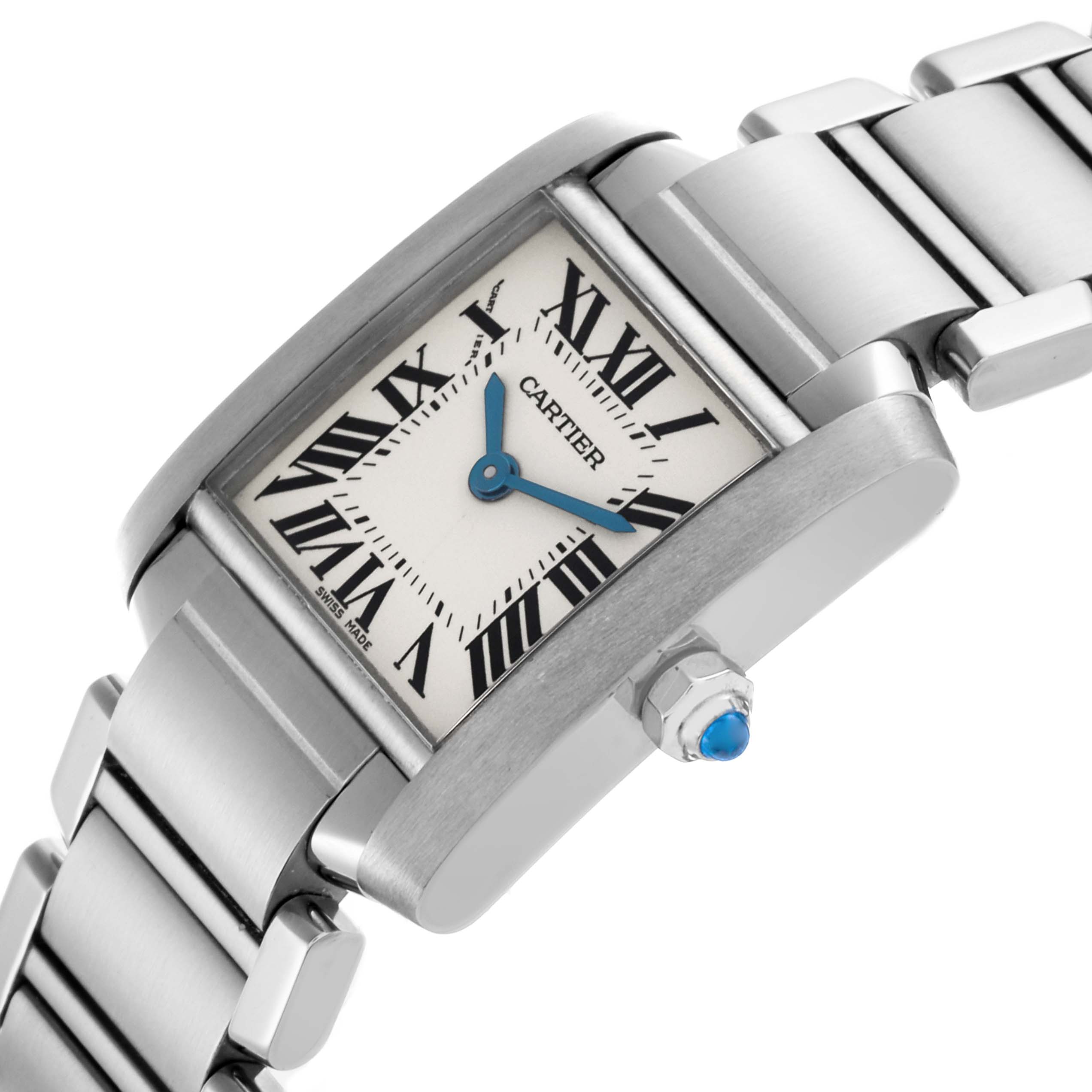 The Cartier Tank Française watch is shown at an angle highlighting the face, Roman numerals, blue hands, and the crown with a blue cabochon.