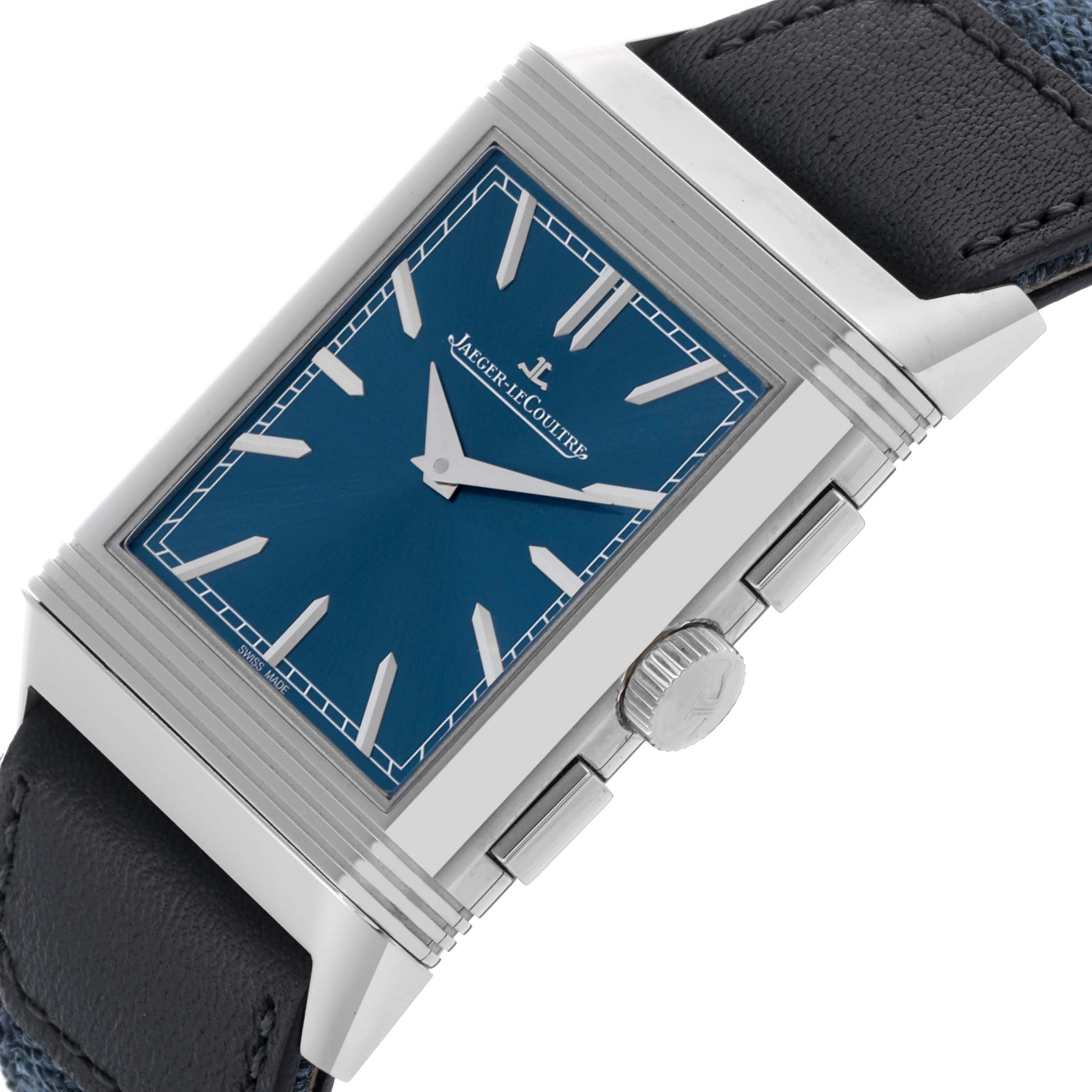 The Jaeger-LeCoultre Reverso watch is shown at an oblique angle, highlighting its blue dial, crown, and rectangular case.