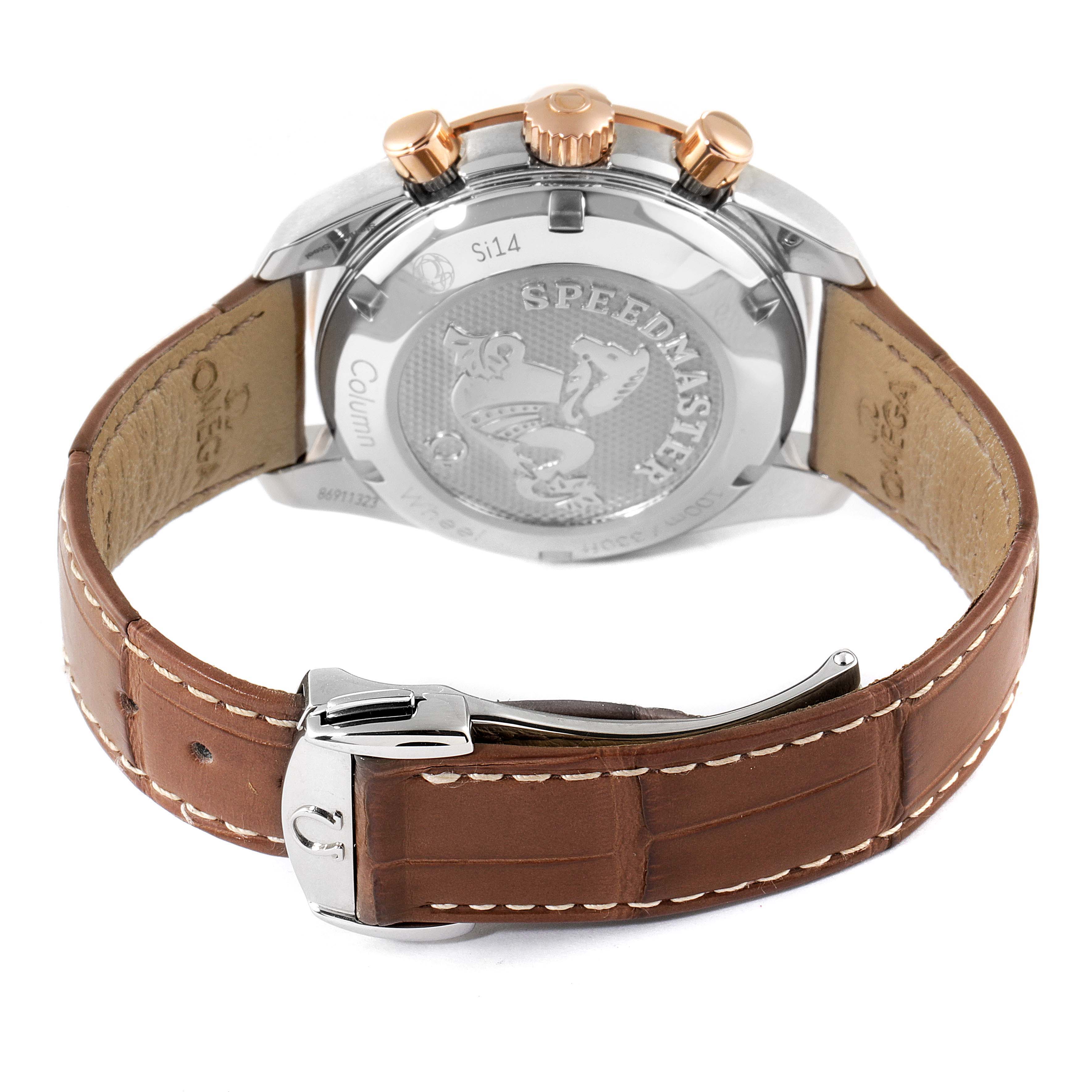 The image shows the back view of an Omega Speedmaster 324.23.38.50.02.002 Men's Steel and Gold (two tone) Silver Dial 324.23.38.50.02.002 Men's Steel and Gold (two tone) Silver Dial watch with three gold push buttons and a brown leather strap.