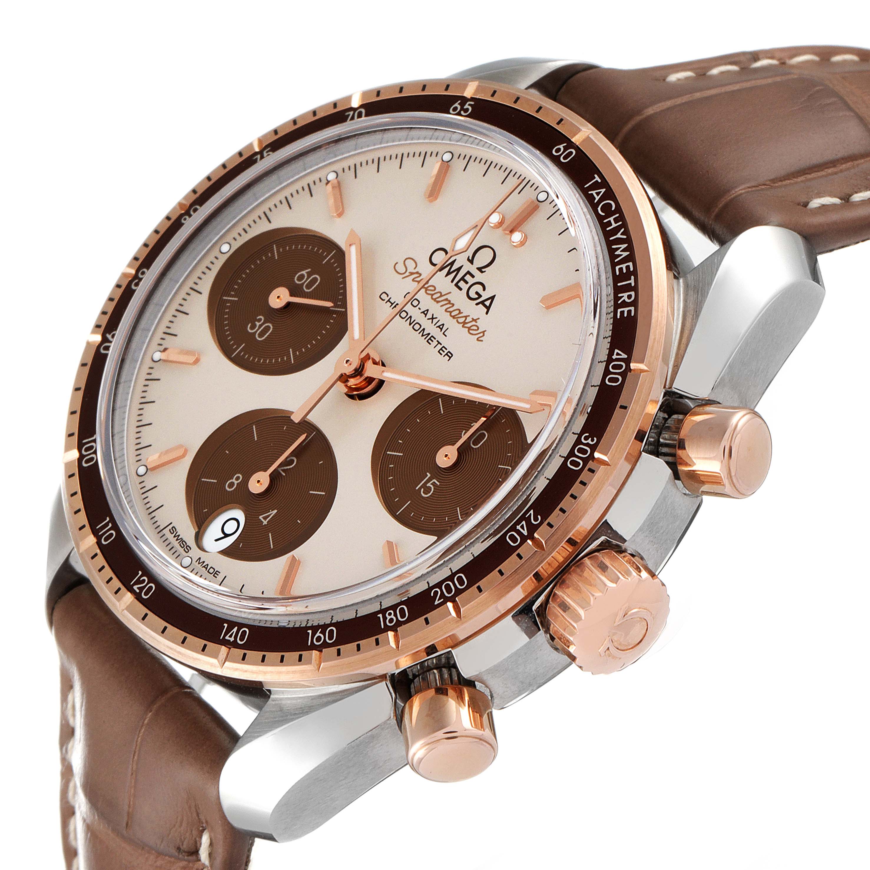 The image shows an angled view of the Omega Speedmaster 324.23.38.50.02.002 Men's Steel and Gold (two tone) Silver Dial 324.23.38.50.02.002 Men's Steel and Gold (two tone) Silver Dial watch, highlighting its face, sub-dials, bezel, and crown on the side.