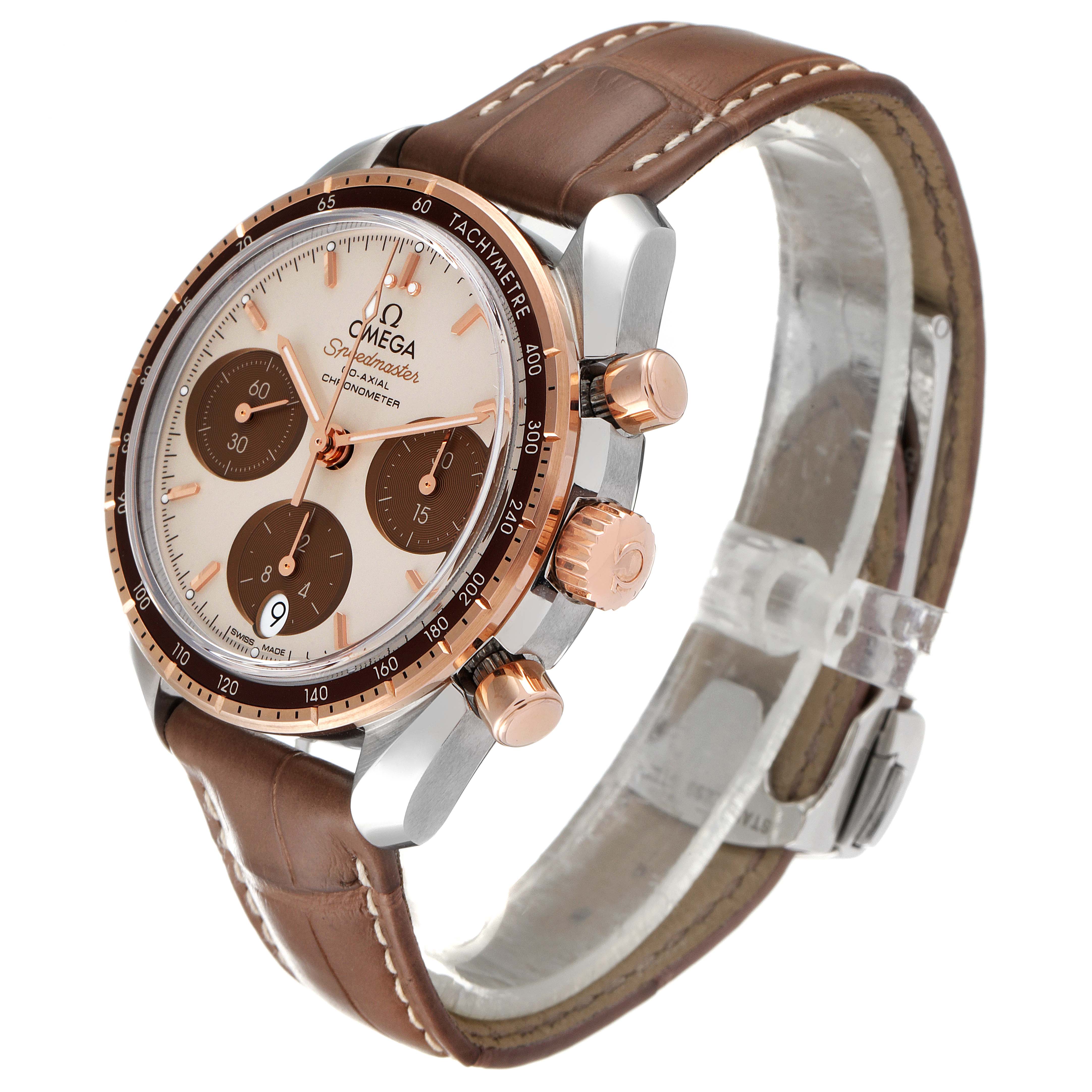 The Omega Speedmaster 324.23.38.50.02.002 Men's Steel and Gold (two tone) Silver Dial 324.23.38.50.02.002 Men's Steel and Gold (two tone) Silver Dial watch is shown at a three-quarter angle, displaying its face, side buttons, and brown leather strap.