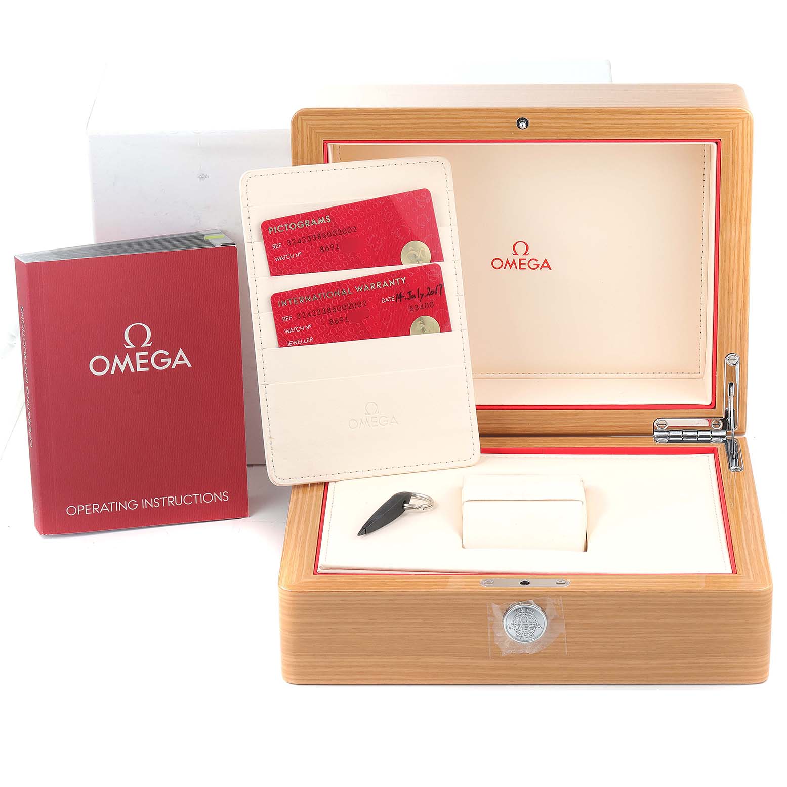 The image shows the Omega Speedmaster 324.23.38.50.02.002 Men's Steel and Gold (two tone) Silver Dial 324.23.38.50.02.002 Men's Steel and Gold (two tone) Silver Dial packaging, including the instruction manual, warranty cards, and watch box from a front angle.