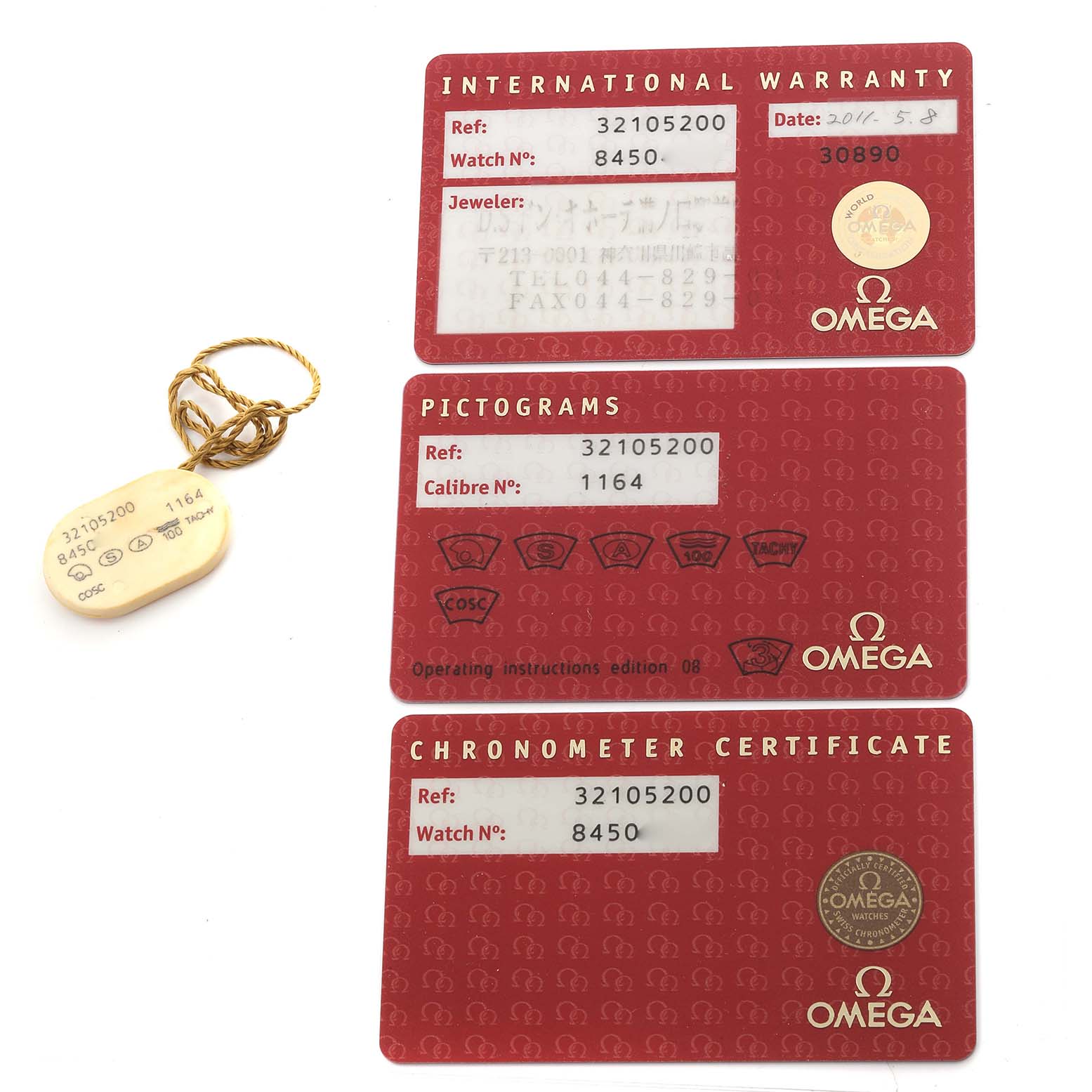 The image shows warranty and certification cards for an Omega Speedmaster 3210.52.00 Men
s Stainless Steel Black Dial 3210.52.00 Men
s Stainless Steel Black Dial, along with a product tag.