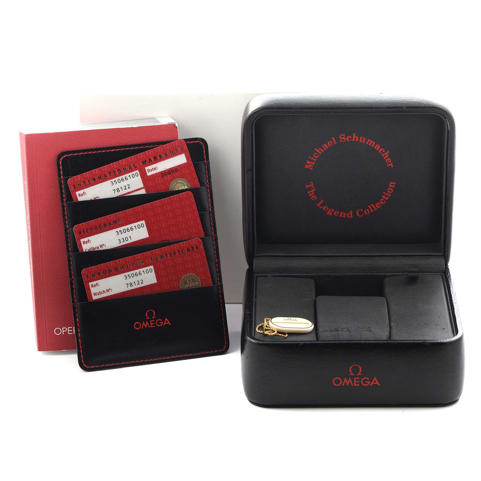 The image shows an Omega Speedmaster 3506.61.00 Men
s Stainless Steel Red Dial 3506.61.00 Men
s Stainless Steel Red Dial watch box, warranty cards, and a holder from a front angle.
