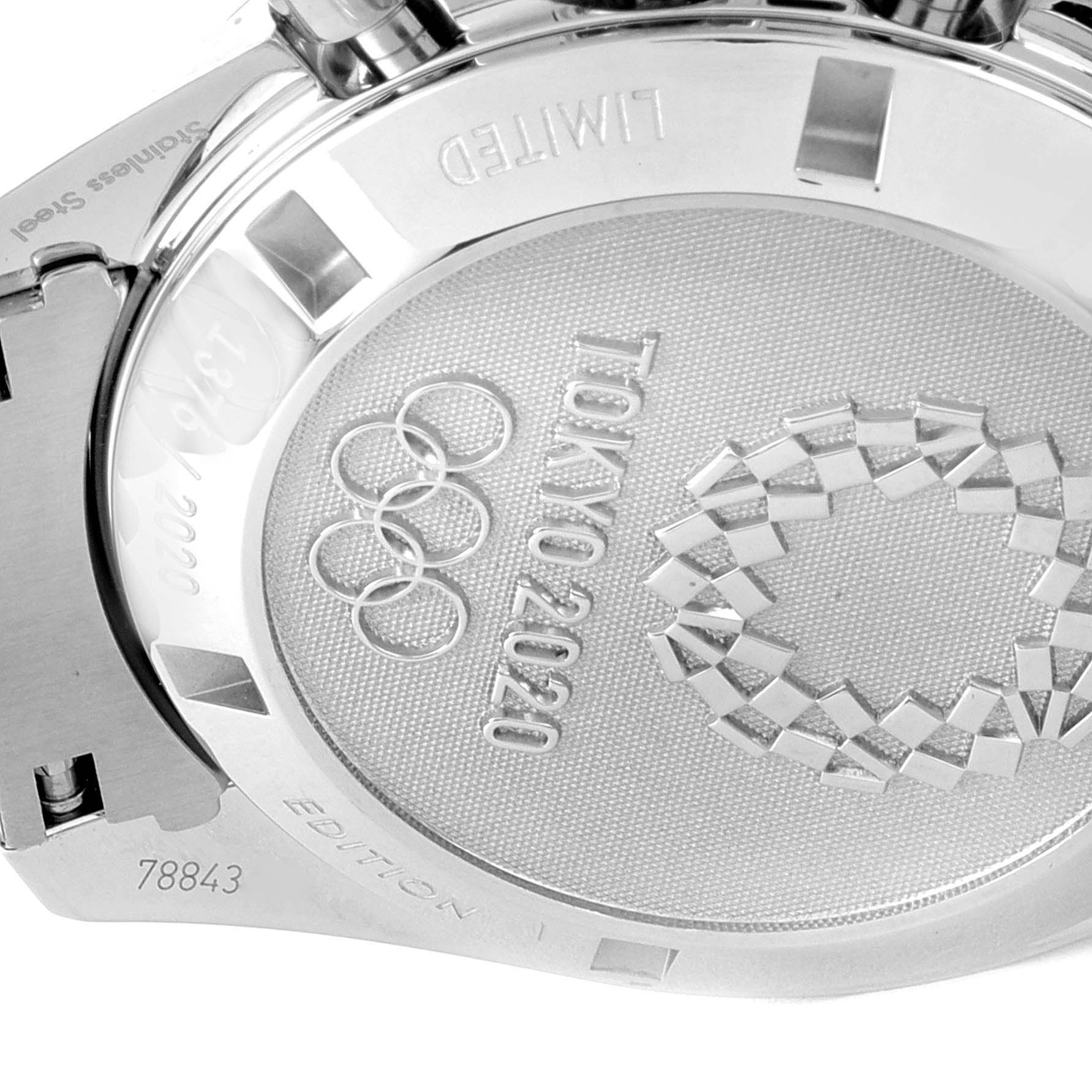 The image shows the back of an Omega Speedmaster 522.30.42.30.04.001 Men's Stainless Steel White Dial 522.30.42.30.04.001 Men's Stainless Steel White Dial watch, highlighting the engravings related to the Tokyo 2020 Olympics.