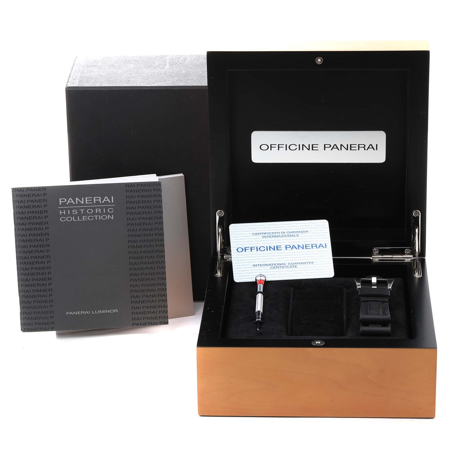 The image shows a Panerai Luminor PAM00000 Men's Stainless Steel Black Dial PAM00000 Men's Stainless Steel Black Dial watch box and accessories, including a booklet, warranty card, strap, and a tool, from a front angle.