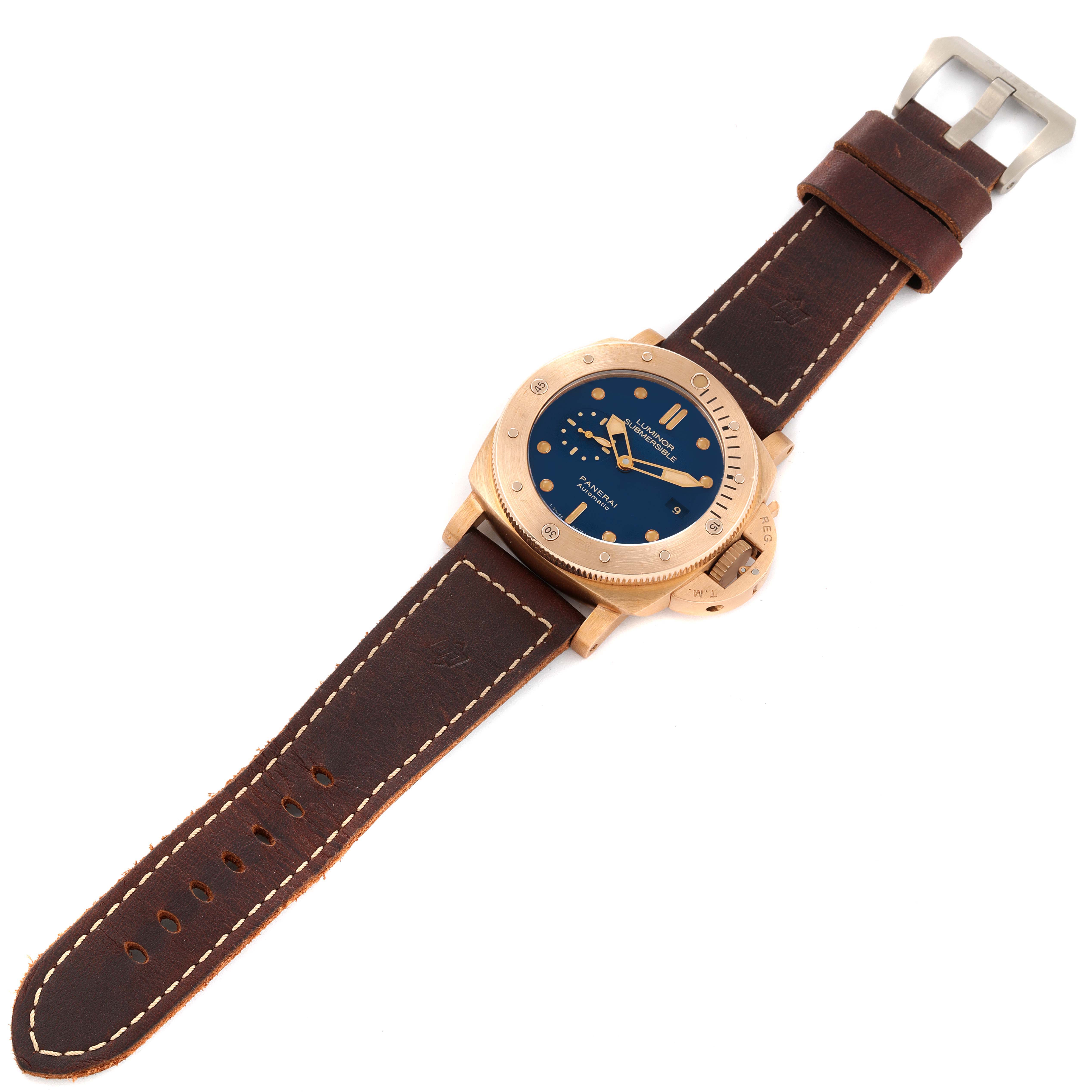 The Panerai Submersible PAM00671 Men's Bronze Blue Dial PAM00671 Men's Bronze Blue Dial watch is shown from a top-down angle, displaying the face, bezel, crown, and leather strap.