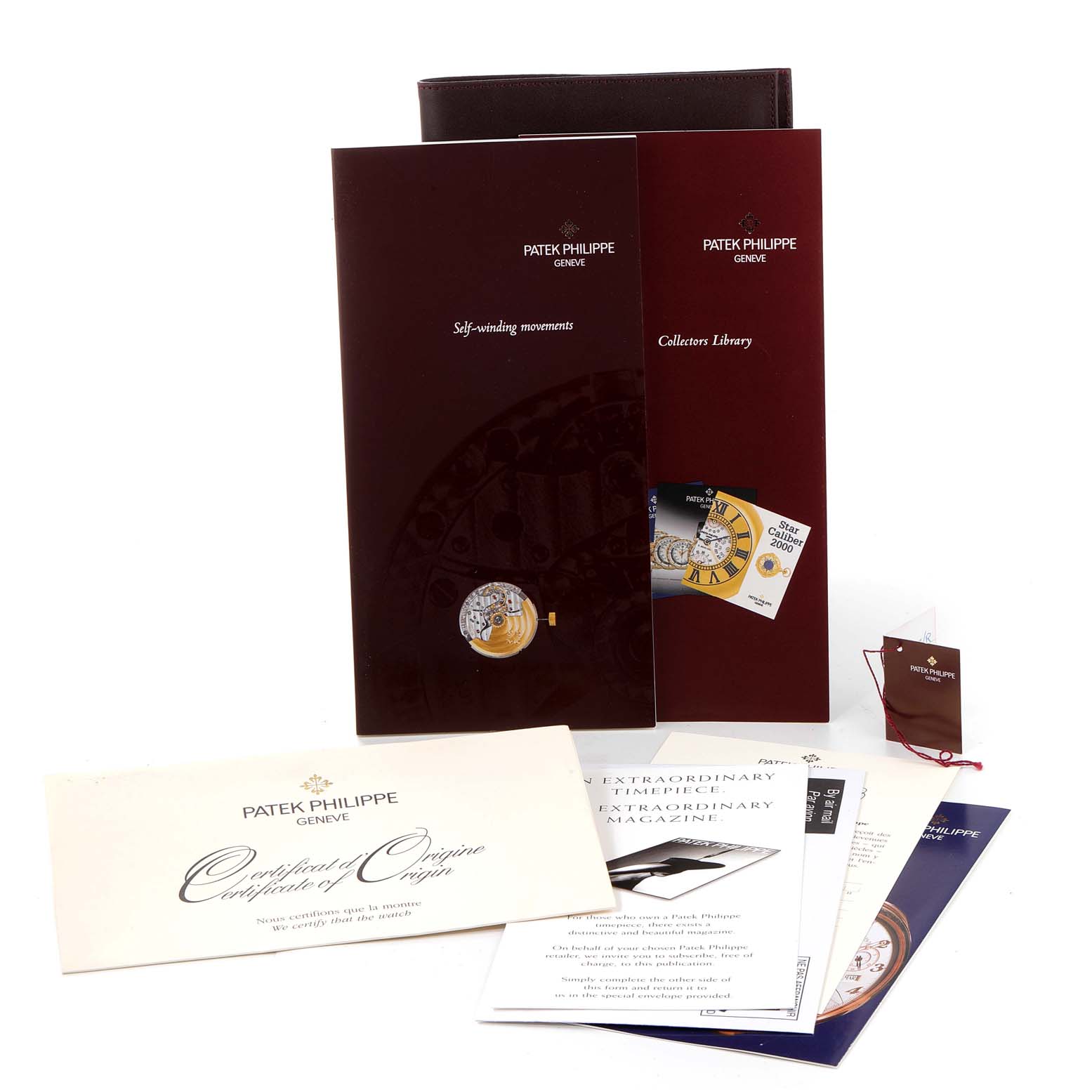 The image shows documentation and booklets related to the Patek Philippe Calatrava 5107R-001 Men
s Rose Gold Silver Dial 5107R-001 Men
s Rose Gold Silver Dial watch model.