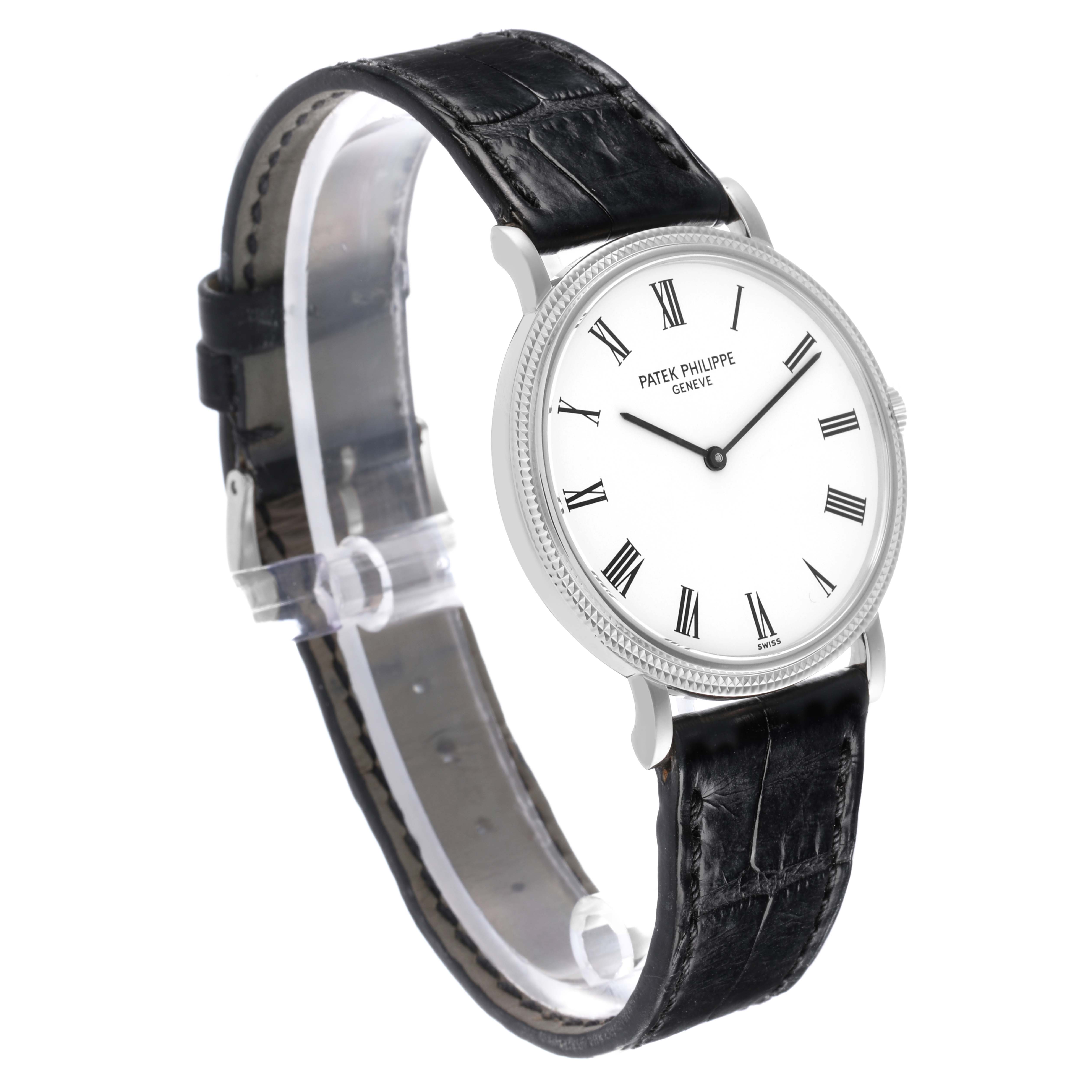 The Patek Philippe Calatrava 5120G Men's White Gold White Dial 5120G Men's White Gold White Dial is shown at a three-quarter angle, displaying its white dial, Roman numerals, and black leather strap.