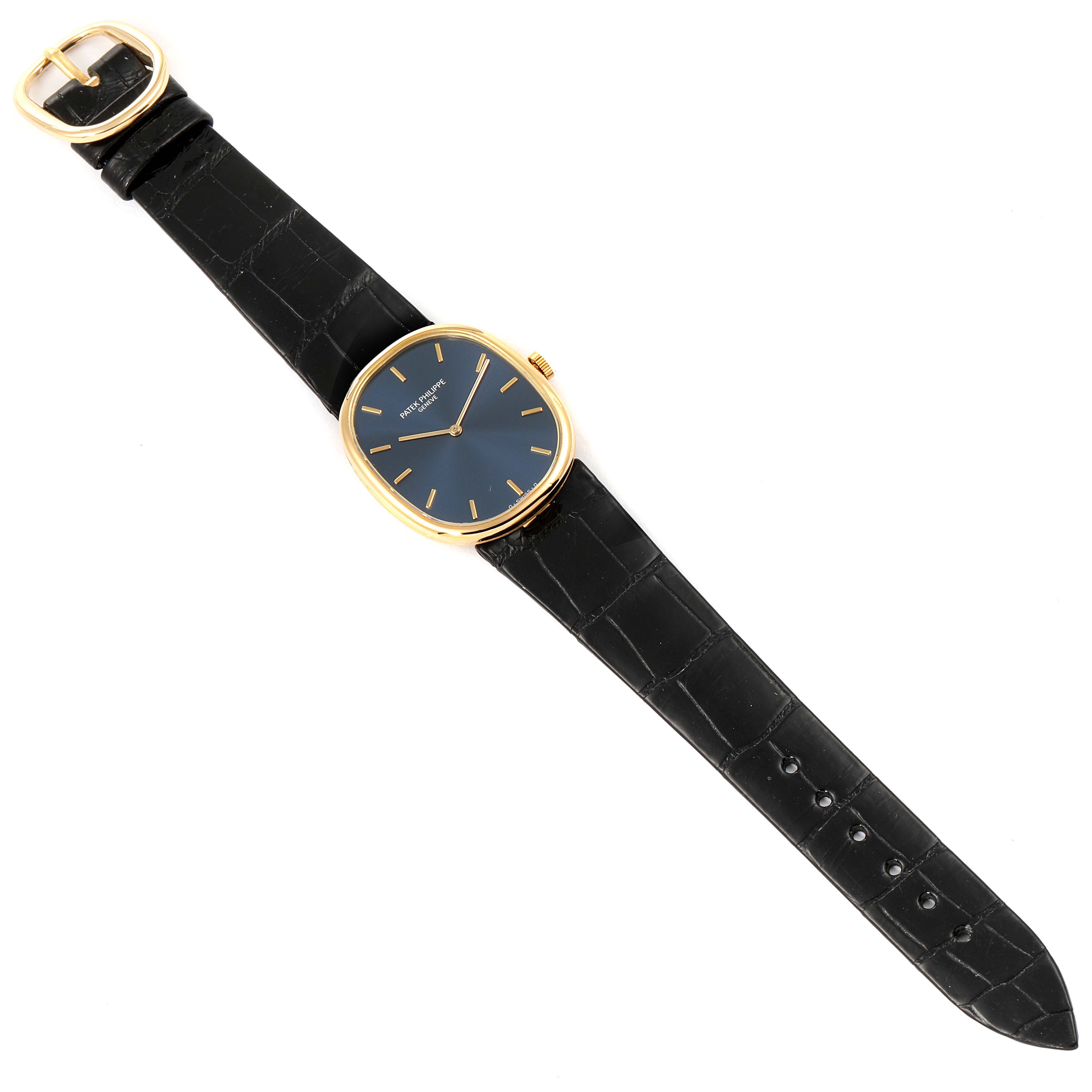 The image shows a top-down view of a Patek Philippe Golden Ellipse 3848 Men's Yellow Gold Blue Dial 3848 Men's Yellow Gold Blue Dial watch with a black leather strap and gold buckle.