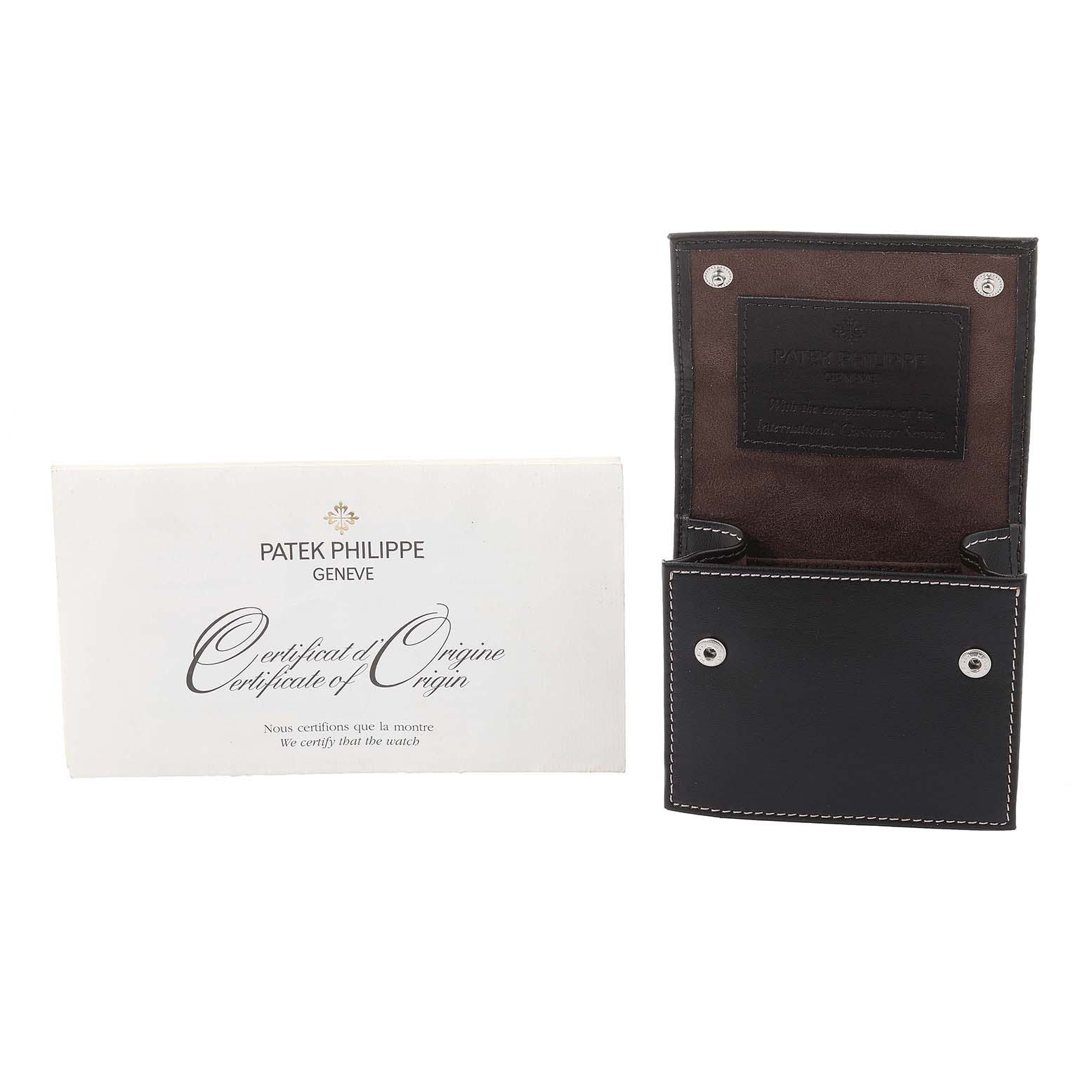 The image shows a Patek Philippe Twenty-4 4910/10A-012 Women's Stainless Steel Blue Dial 4910/10A-012 Women's Stainless Steel Blue Dial certificate of origin and a black leather watch case.